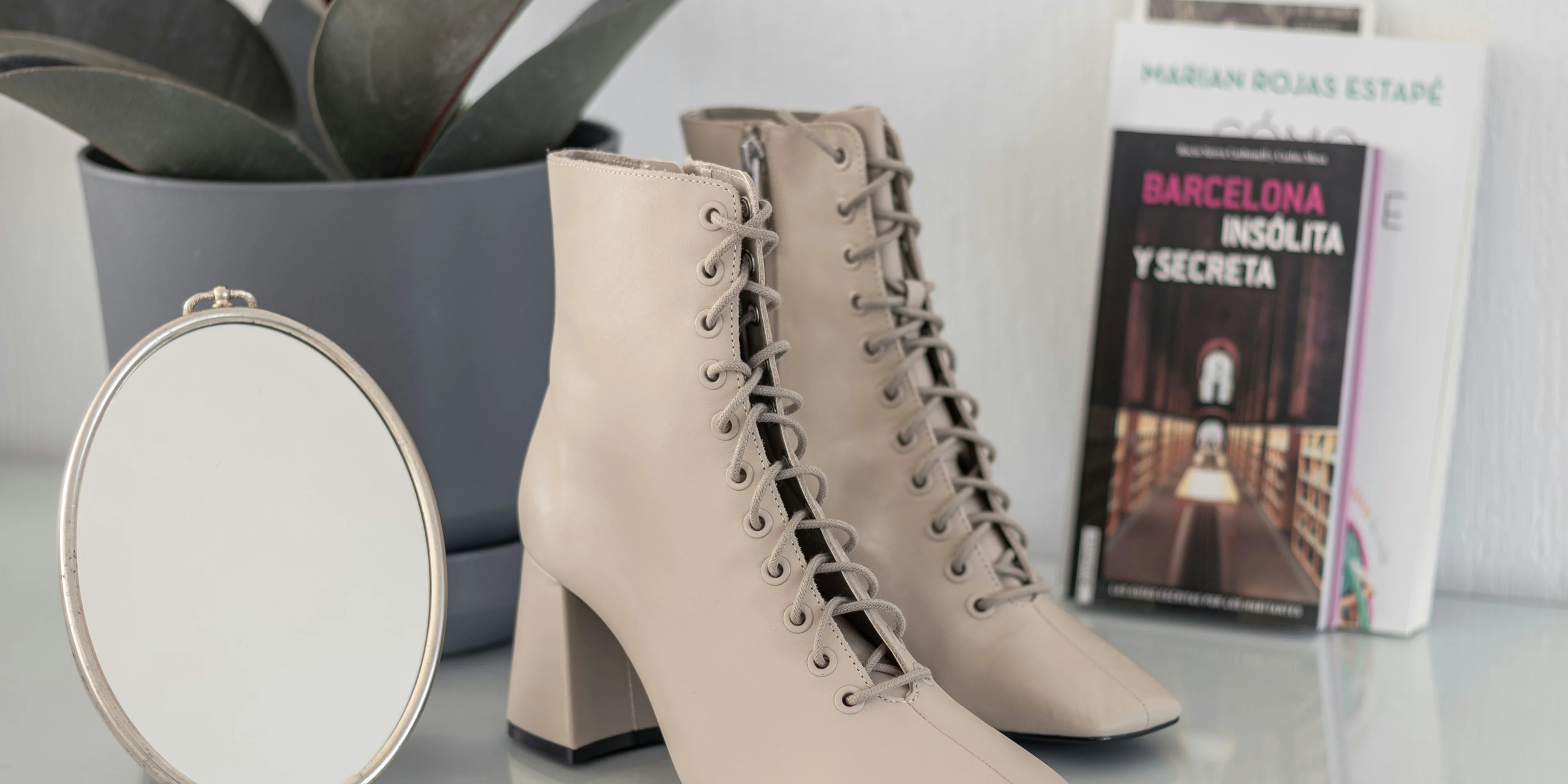 brown leather boots on white table.