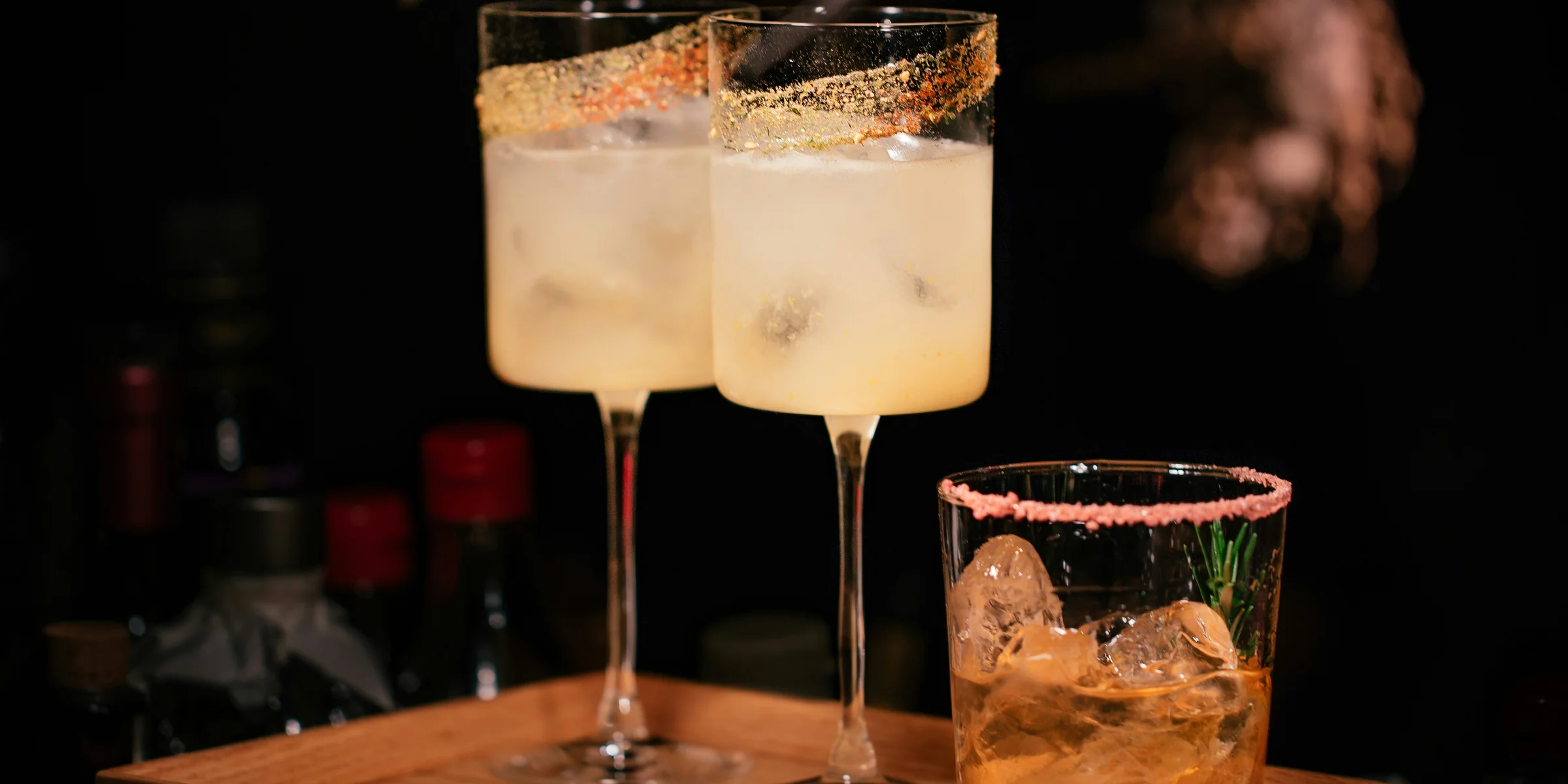 liquor filled wine glasses and rock glass.