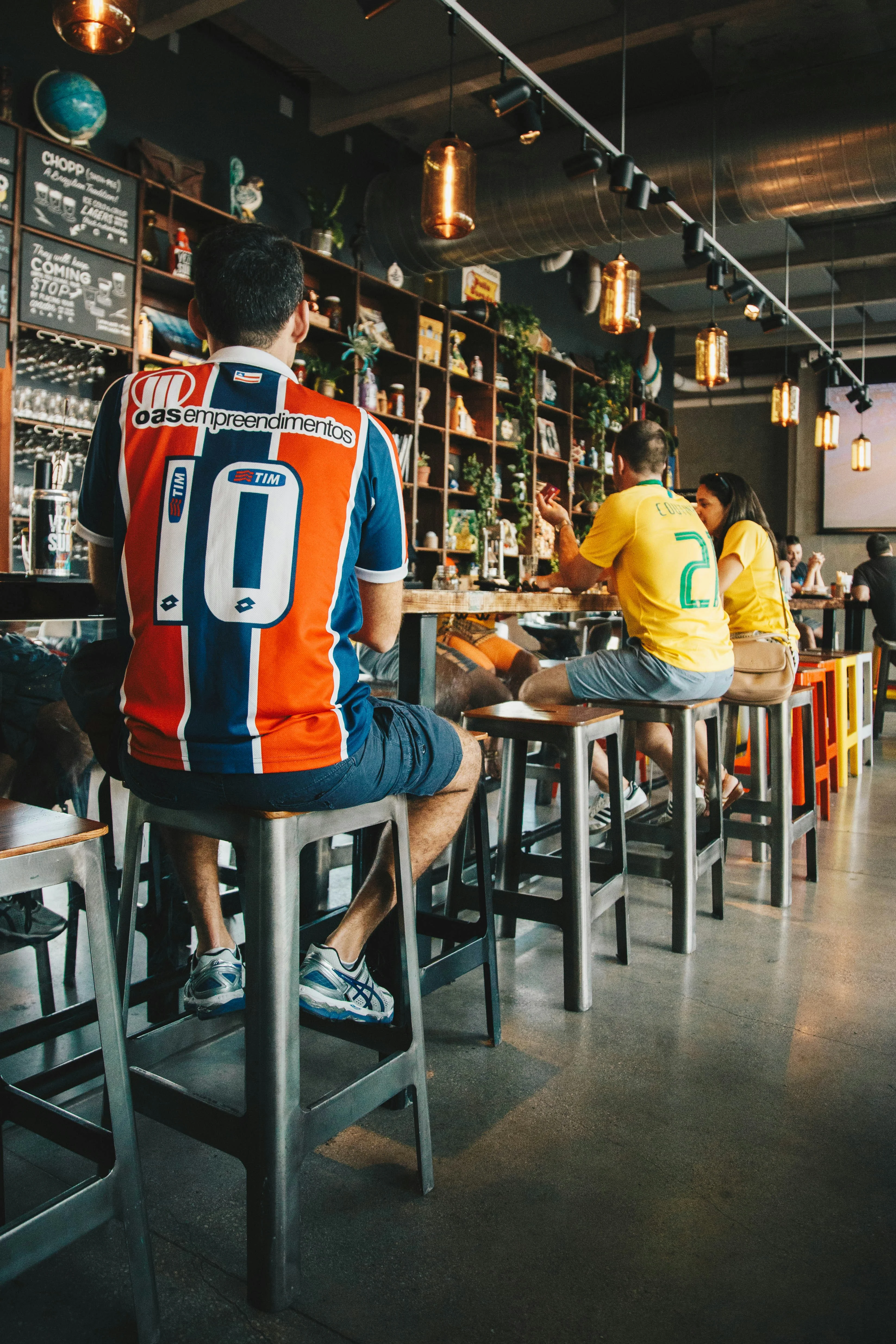 people at a bar wearing jerseys