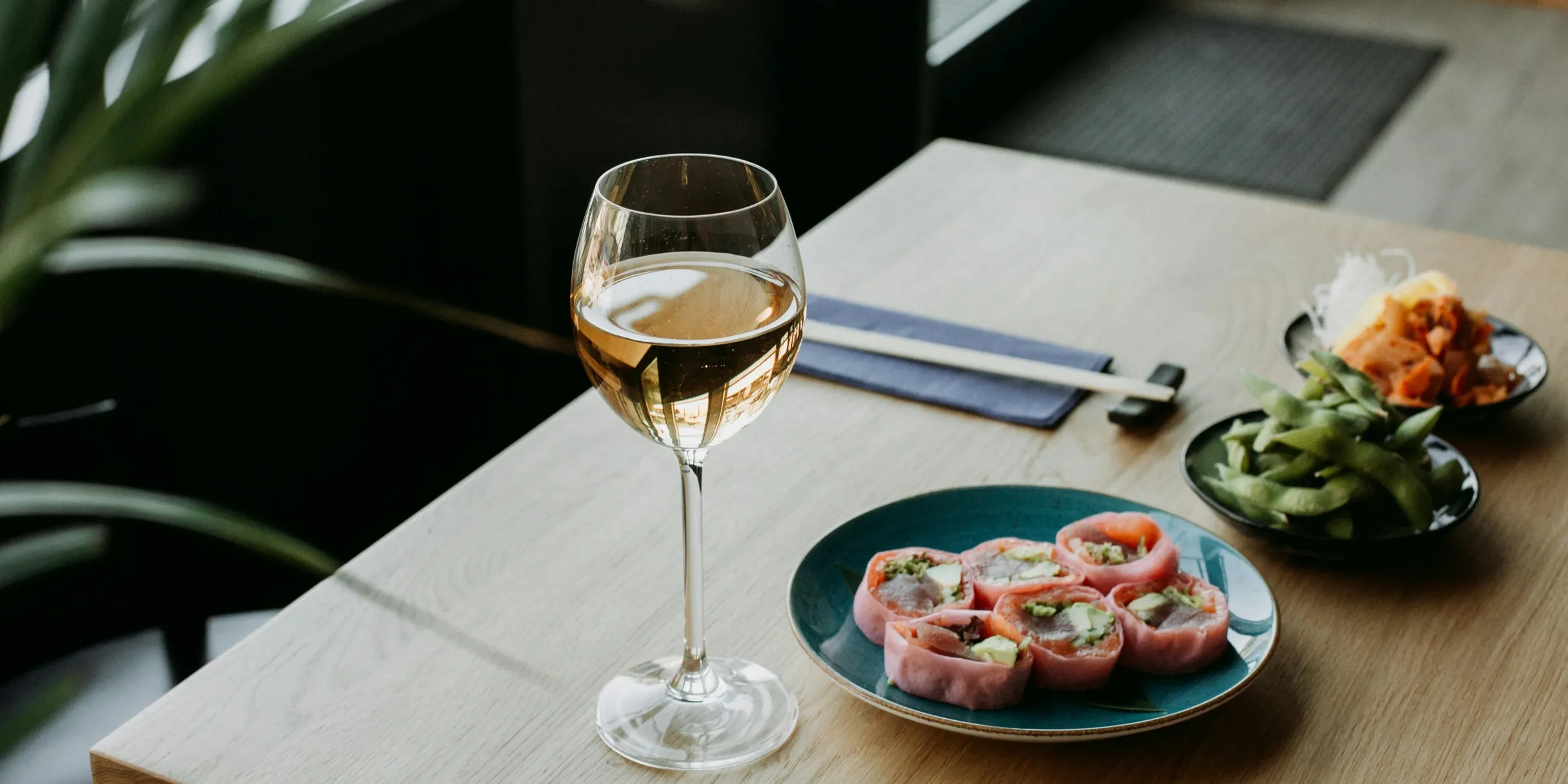 a plate of food and a glass of wine on a table