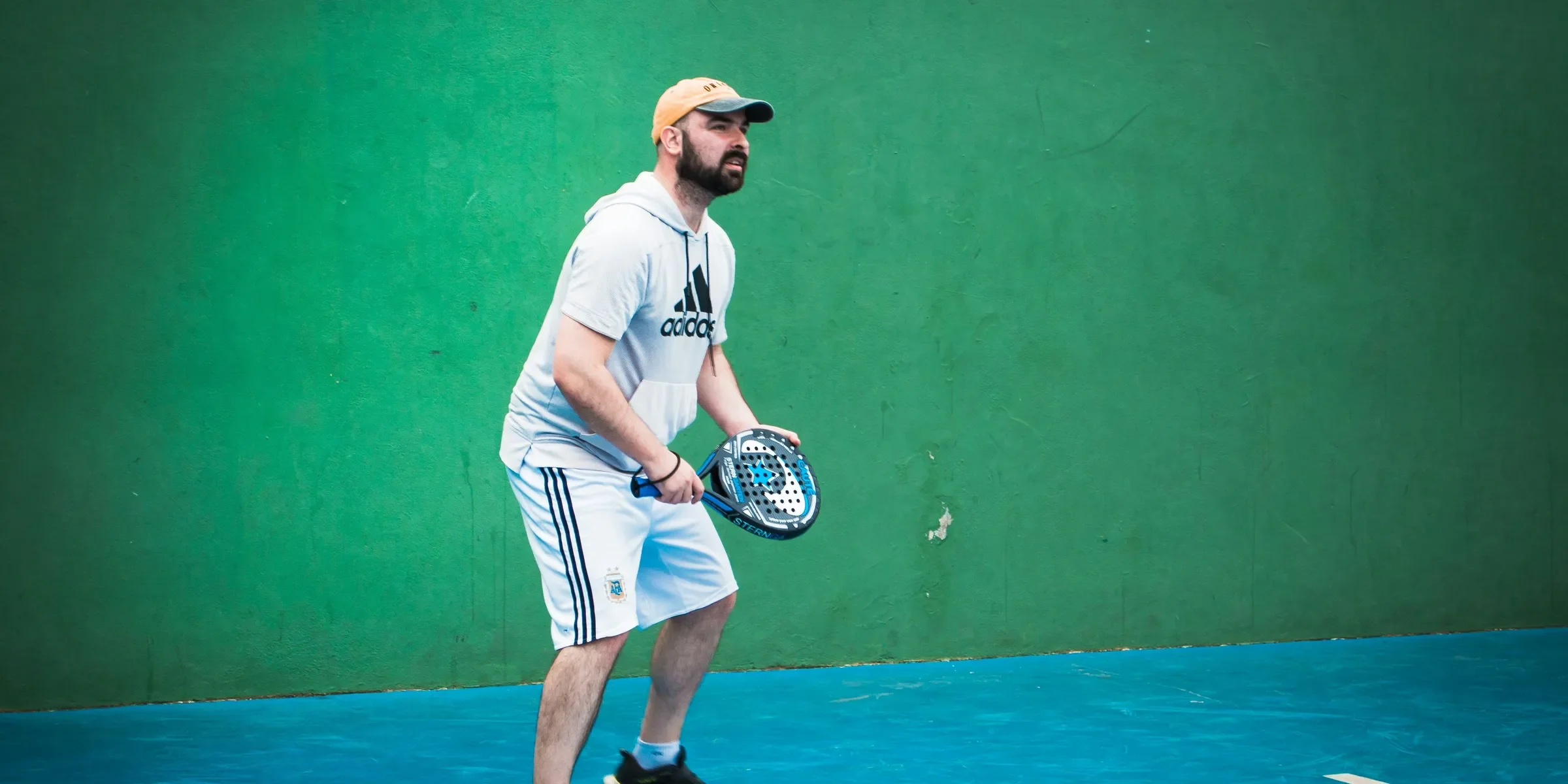 a man holding a tennis racquet on a tennis court