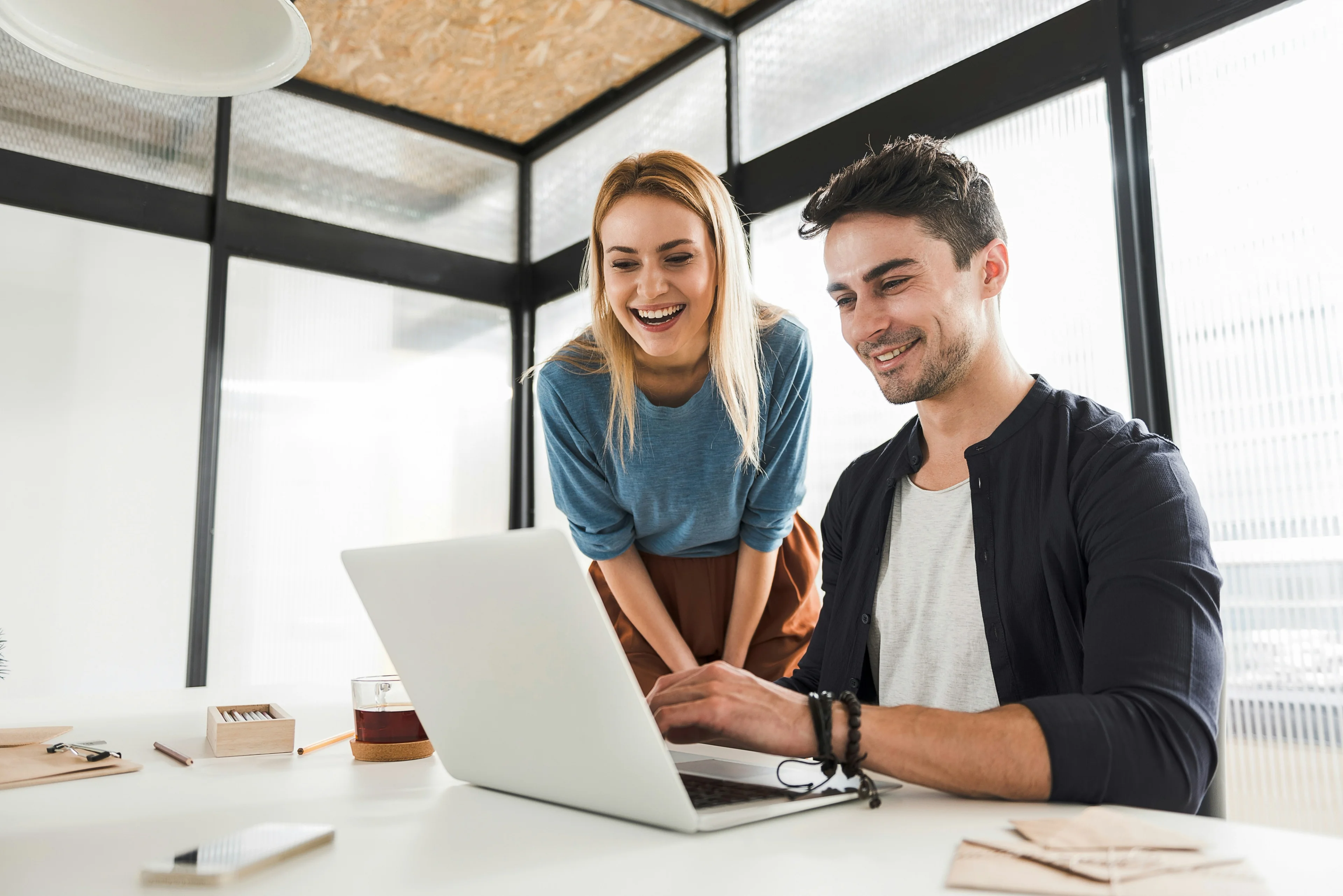 A business team exchanging client appreciation gifts in a modern office