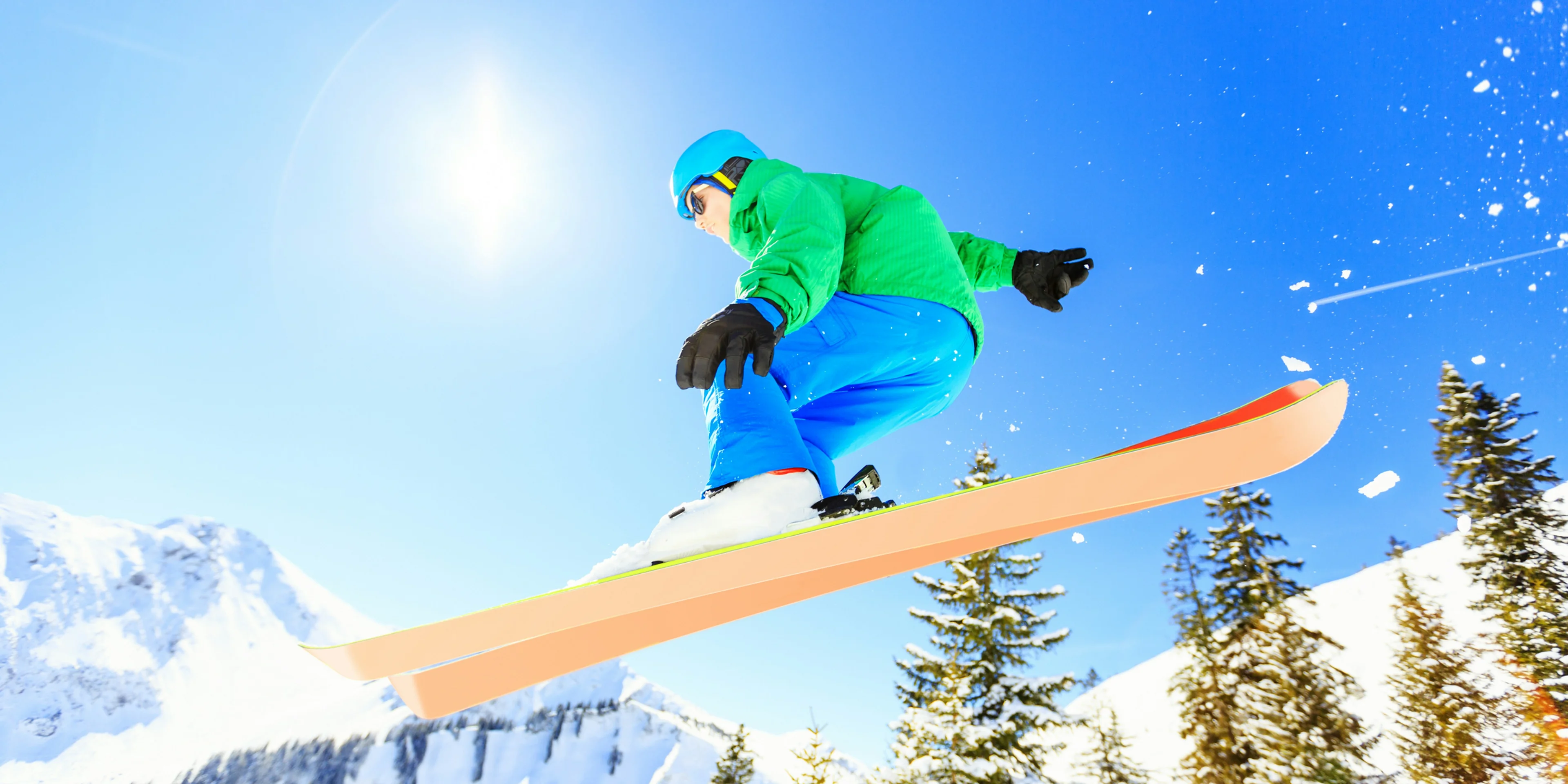person wearing green jacket riding snow skis.