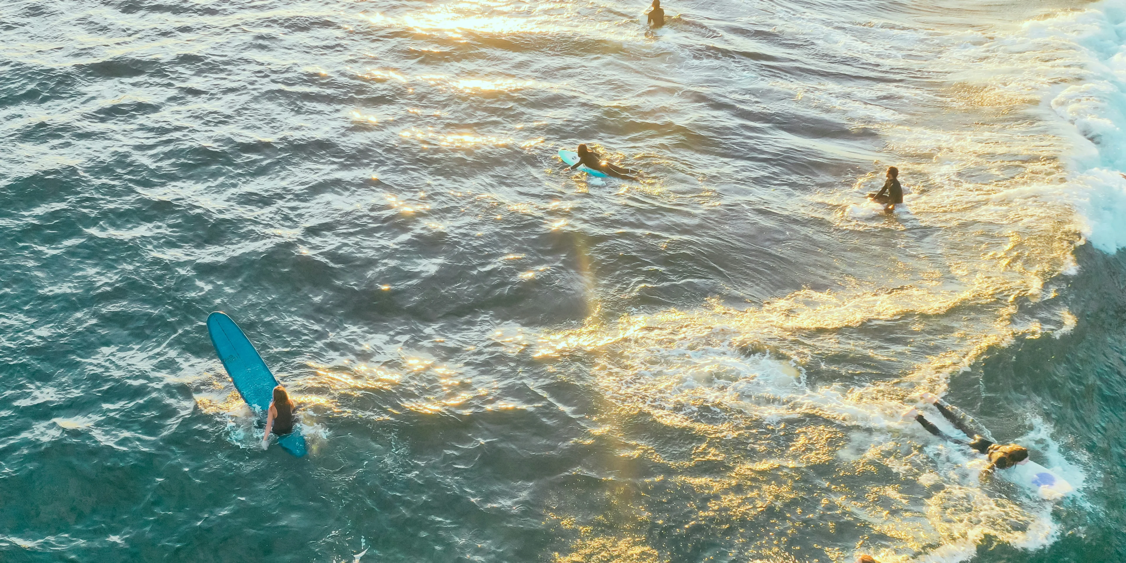 people surfing on ocean at daytime