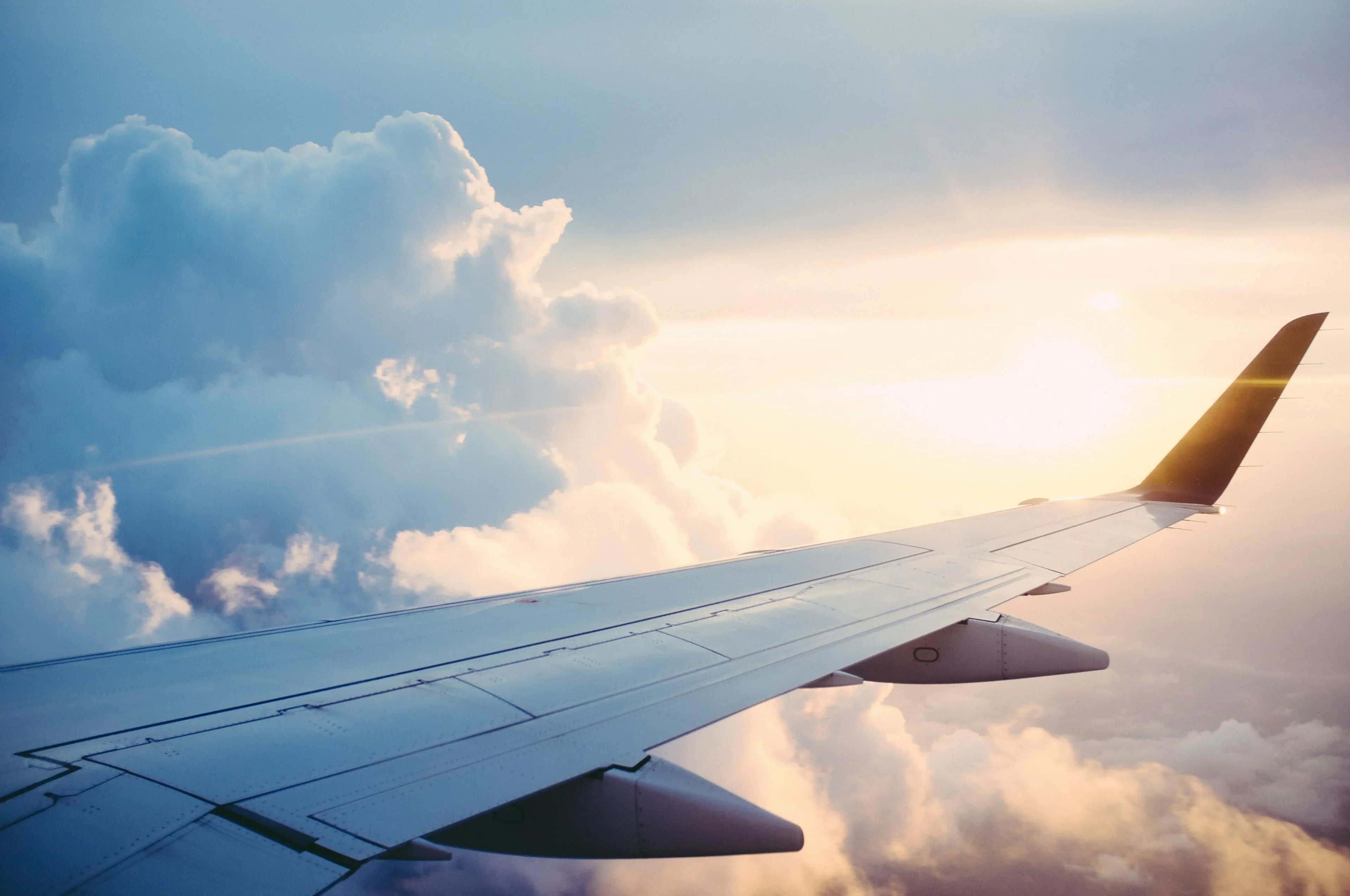 Airplane wing above mountains