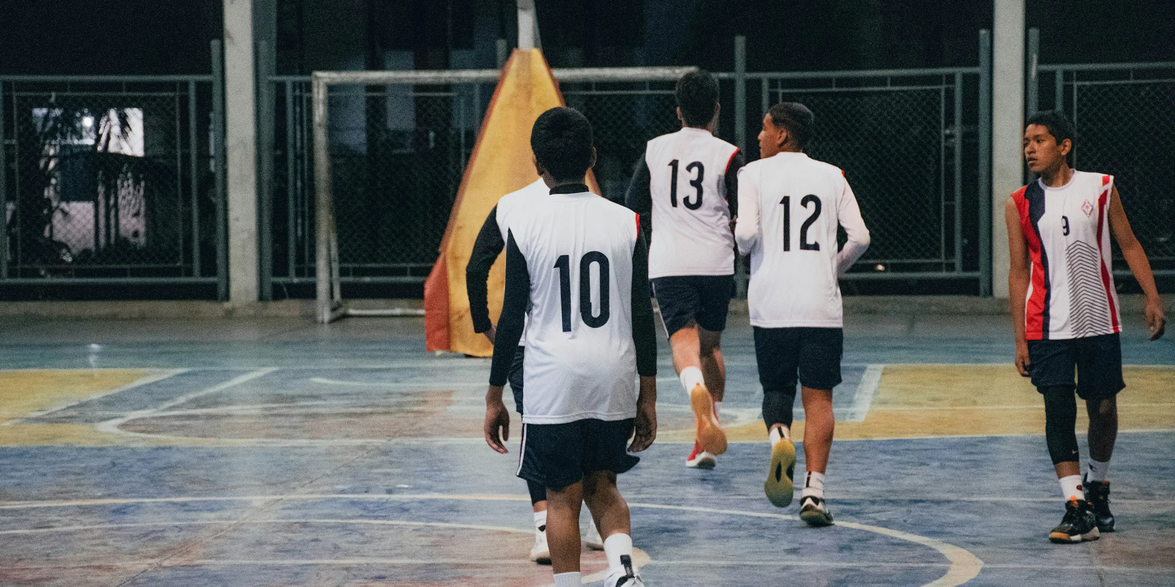 A group of young men playing a game of basketball