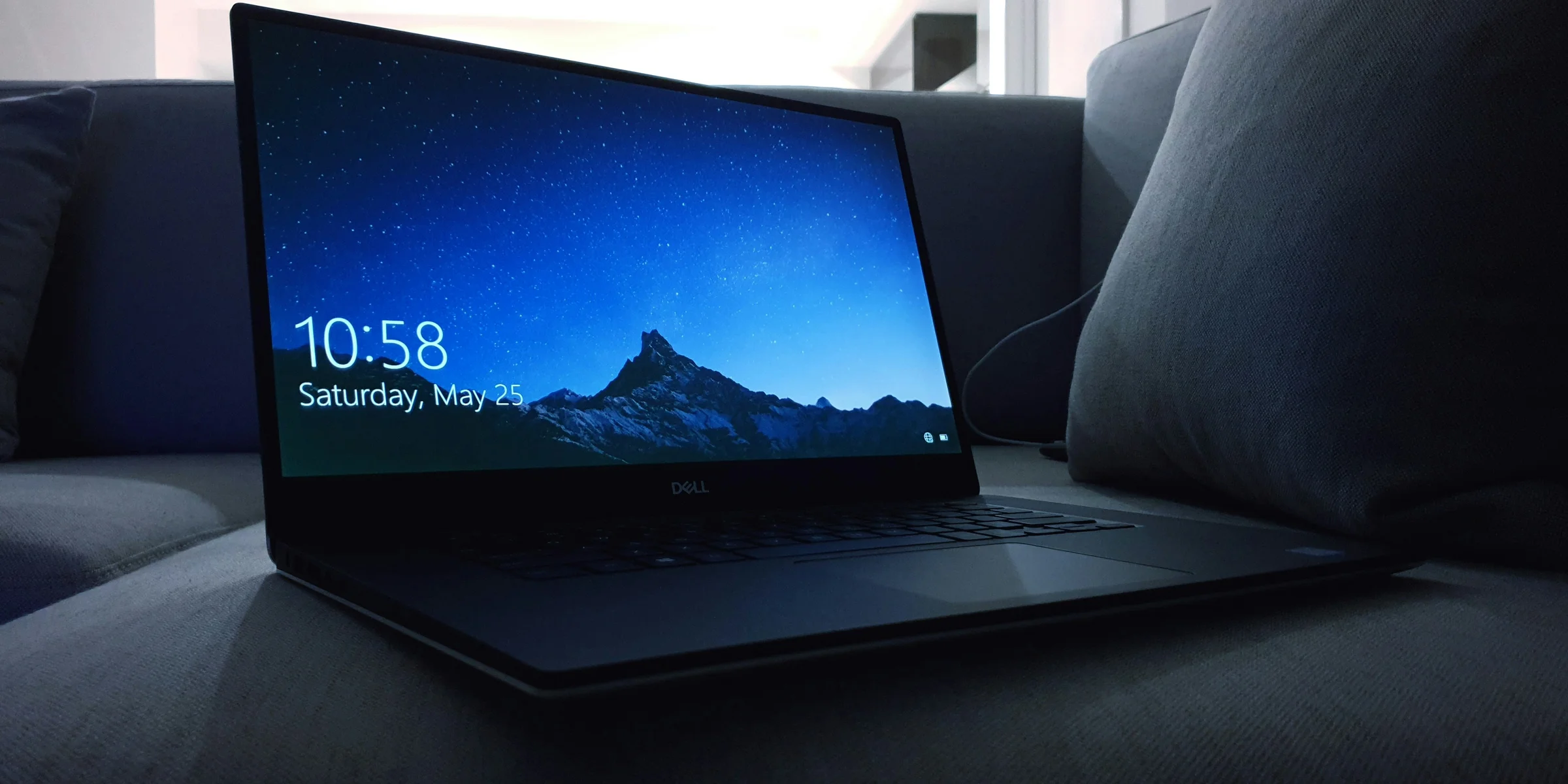 black Dell laptop on sofa.