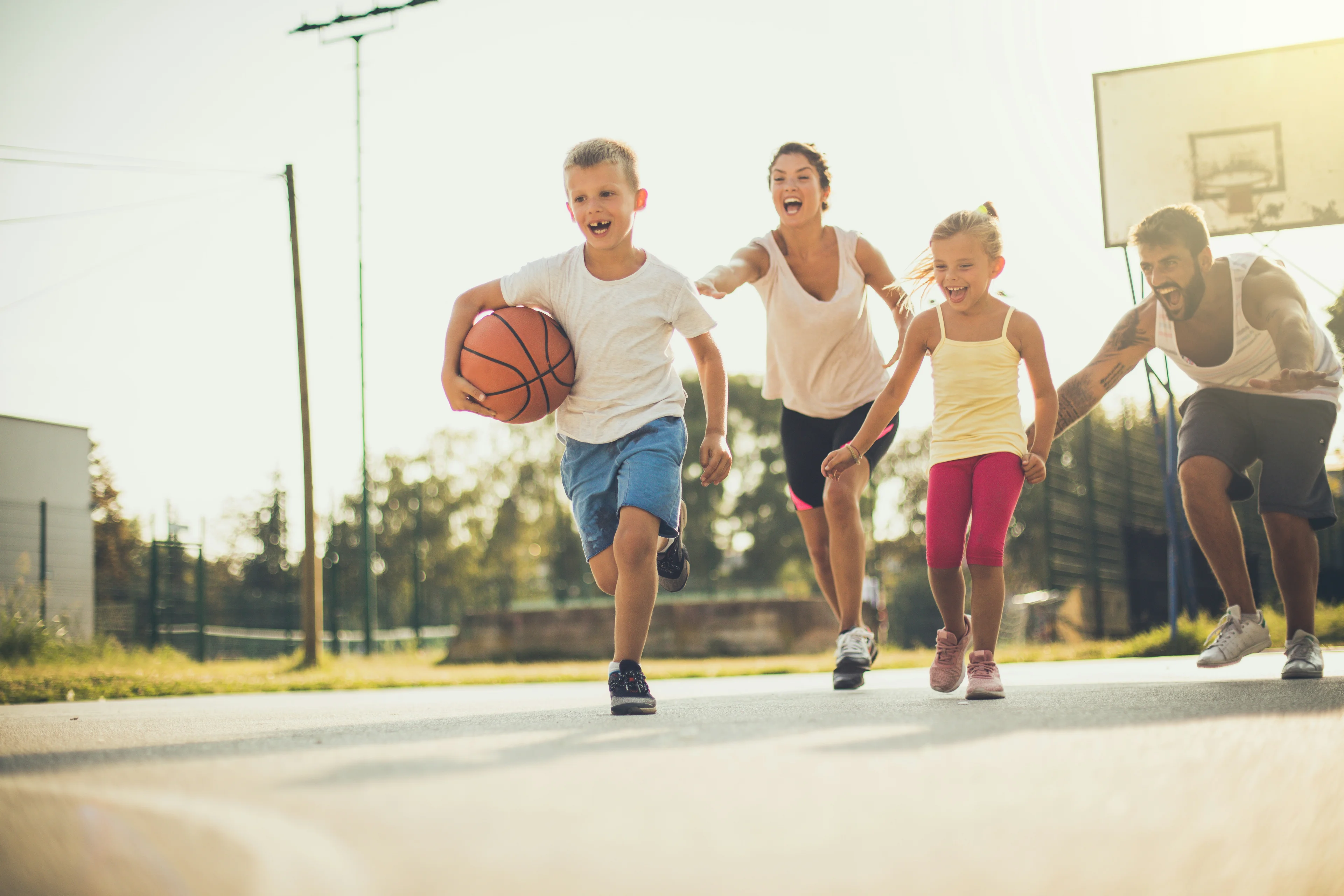 Happy friends playing basketball