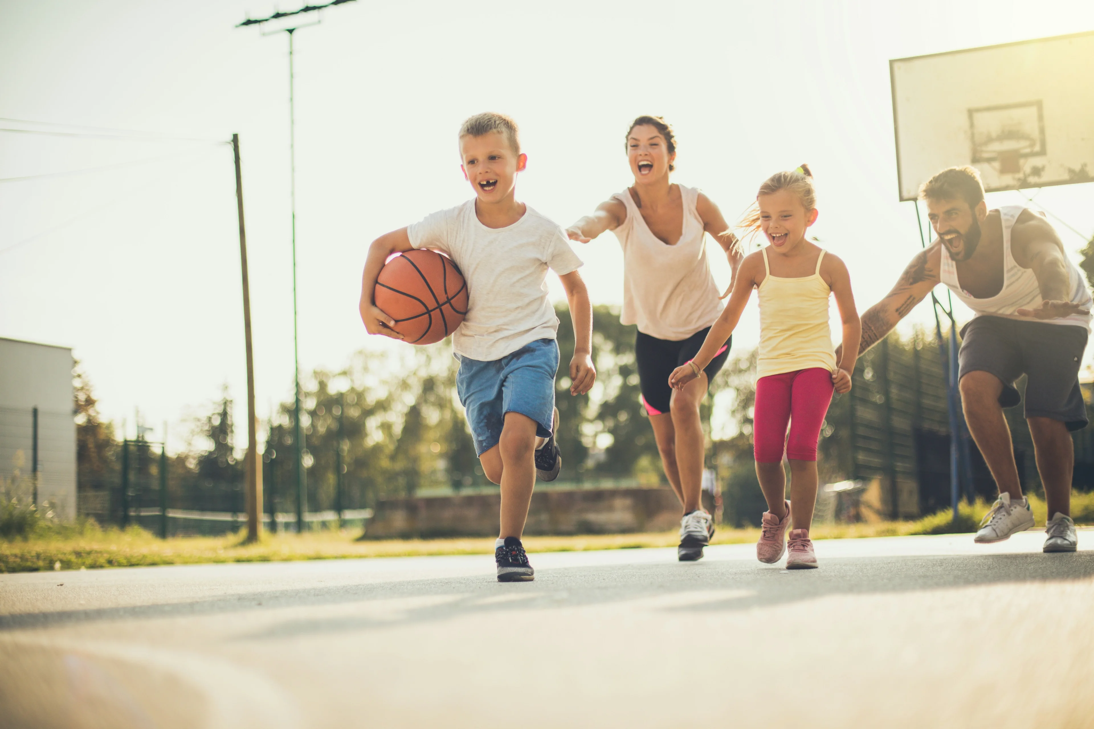 Happy friends playing basketball