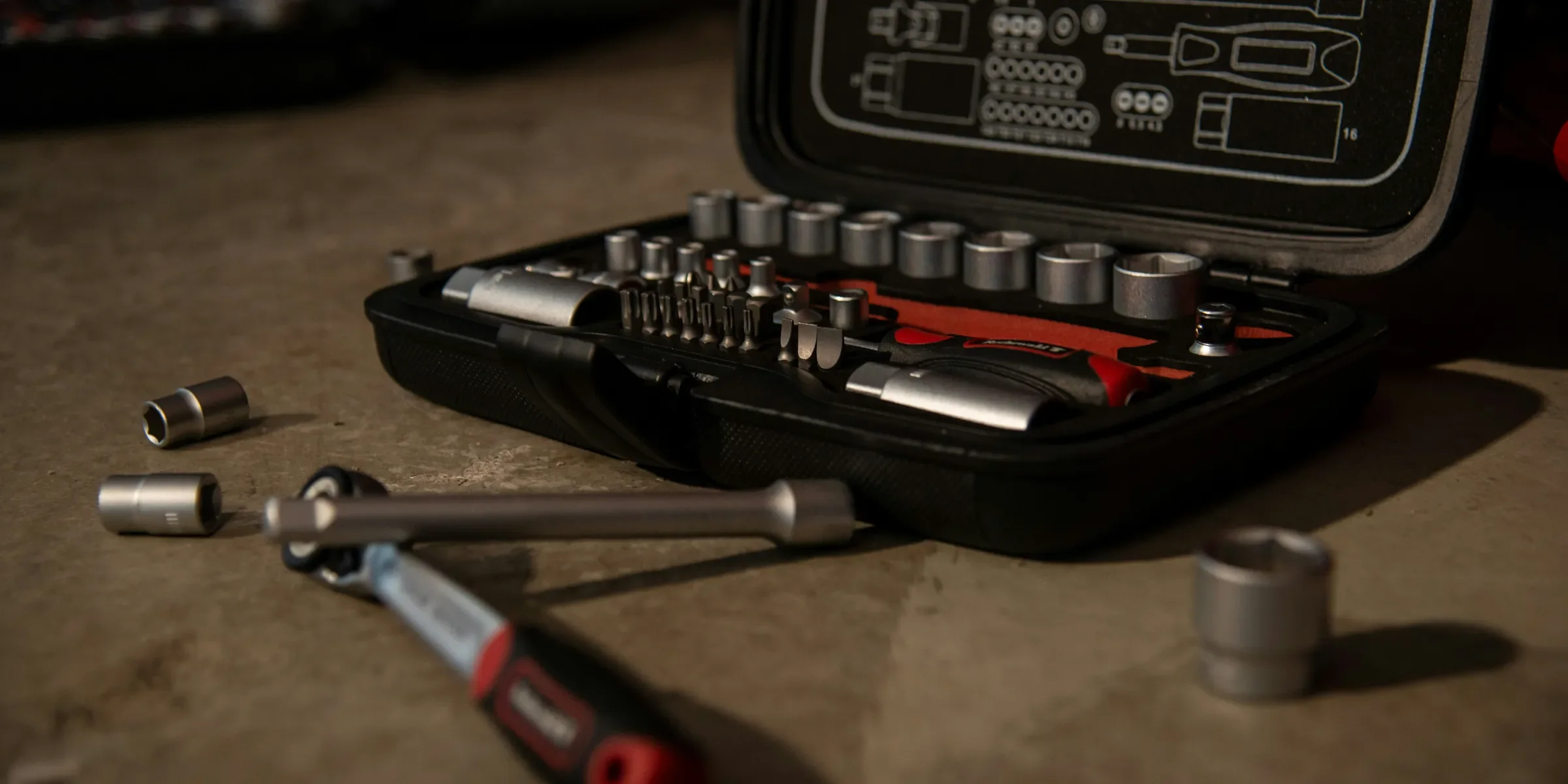 a tool kit with tools in it sitting on a table