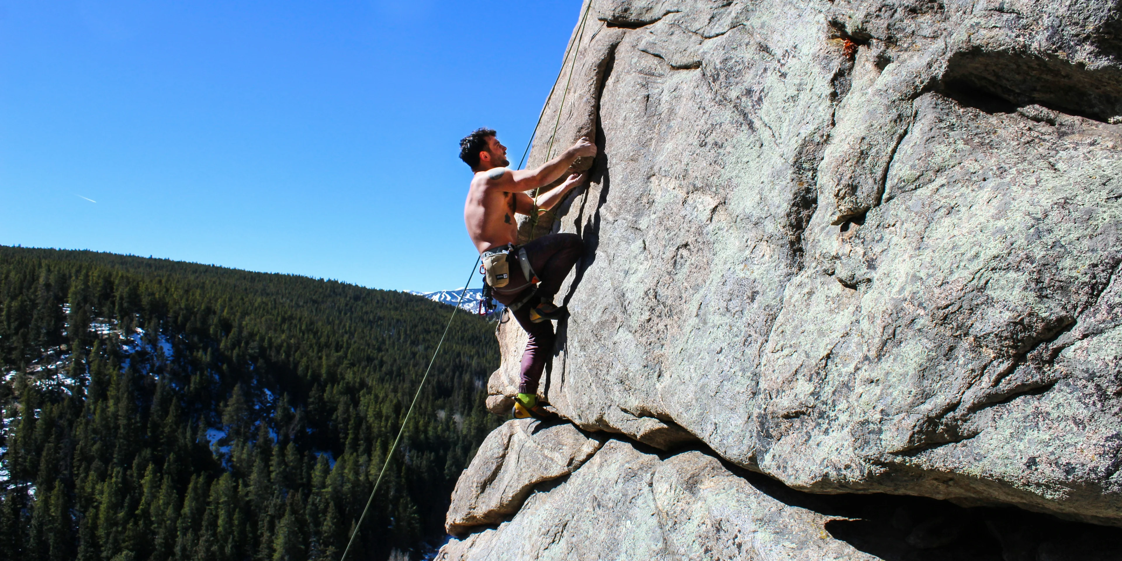 man rockclimbing at daytime