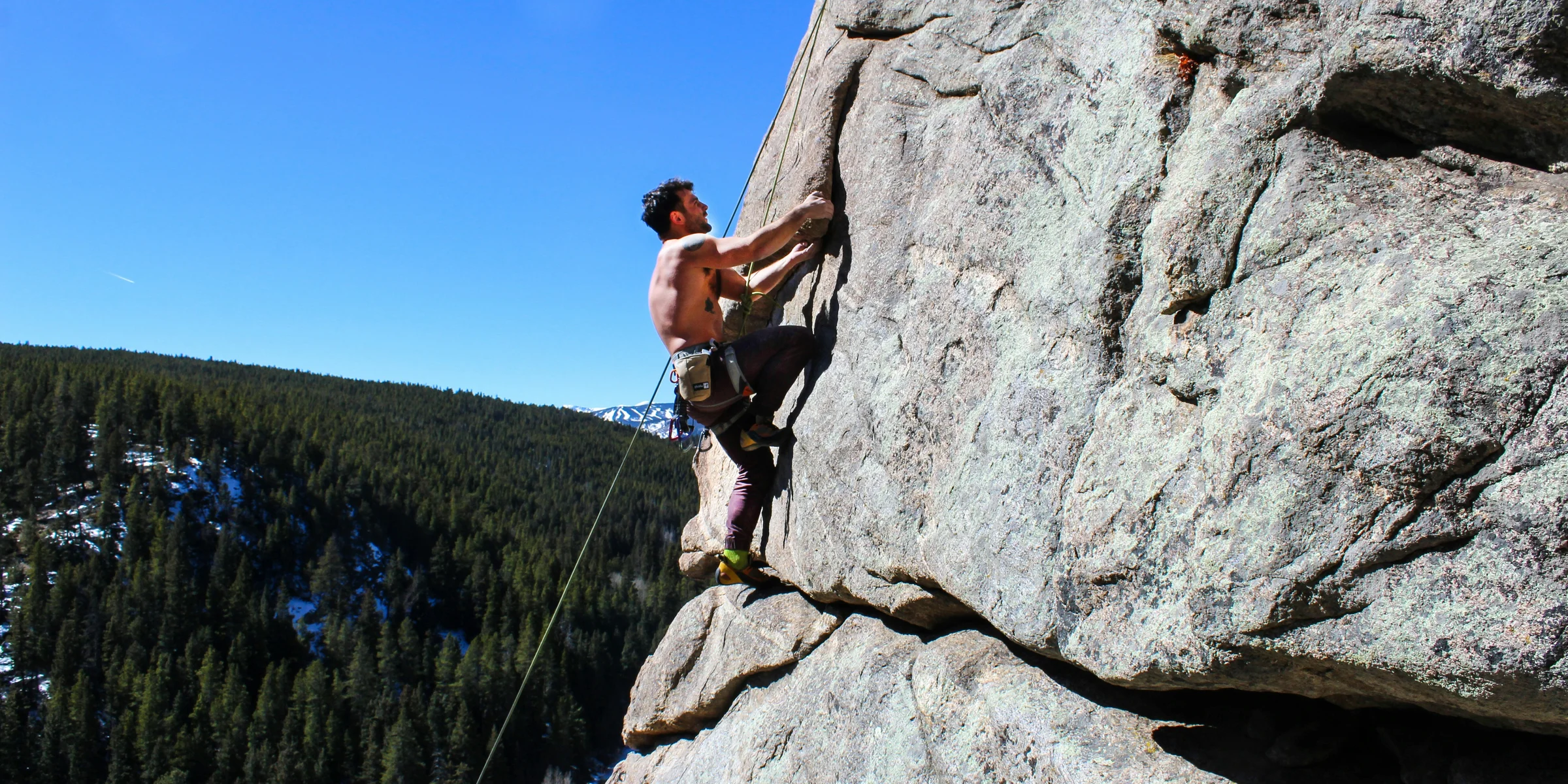 man rockclimbing at daytime