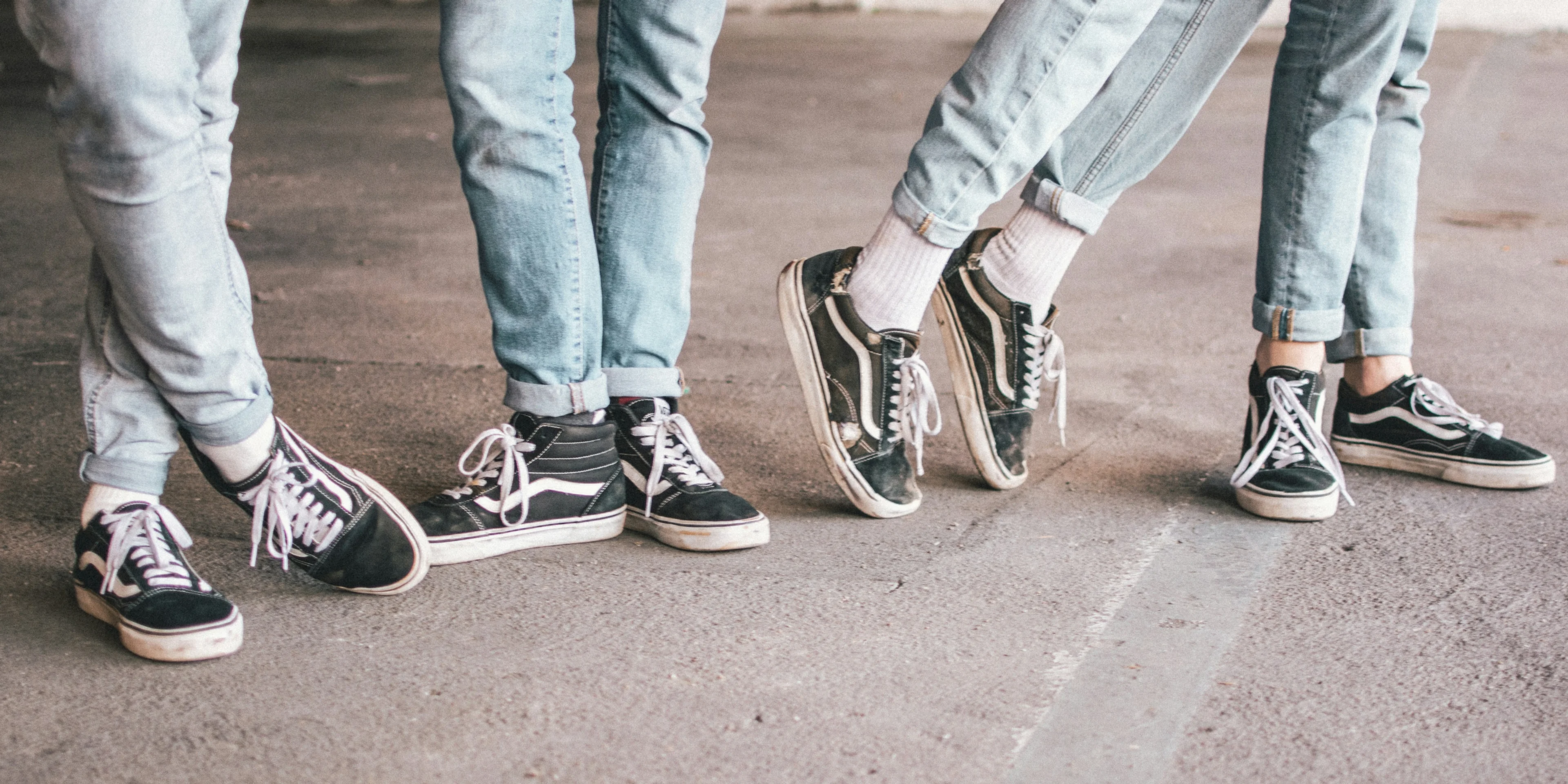 people wearing black Vans Old Skool.