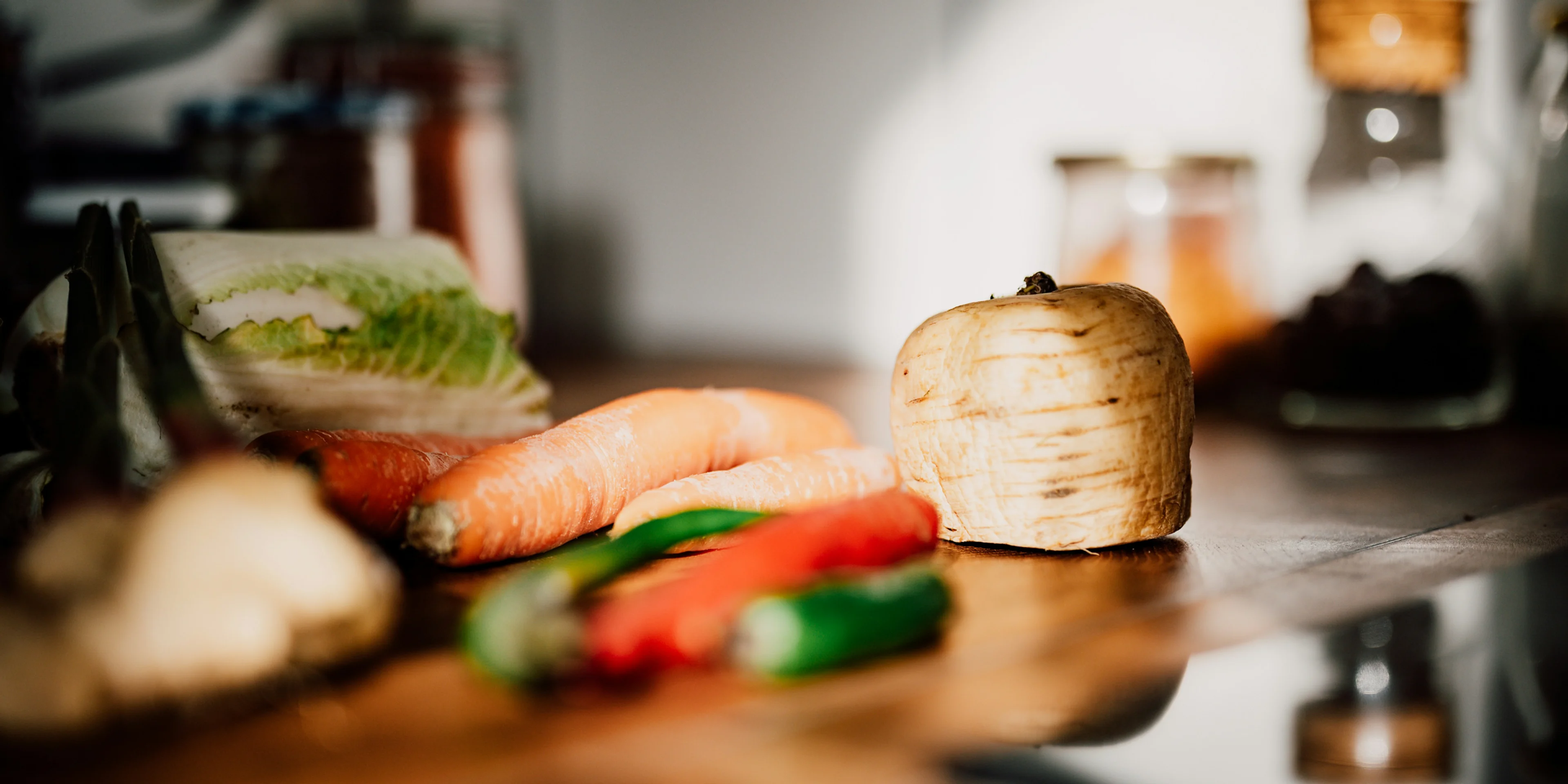 sliced vegetables on brown wooden chopping board.
