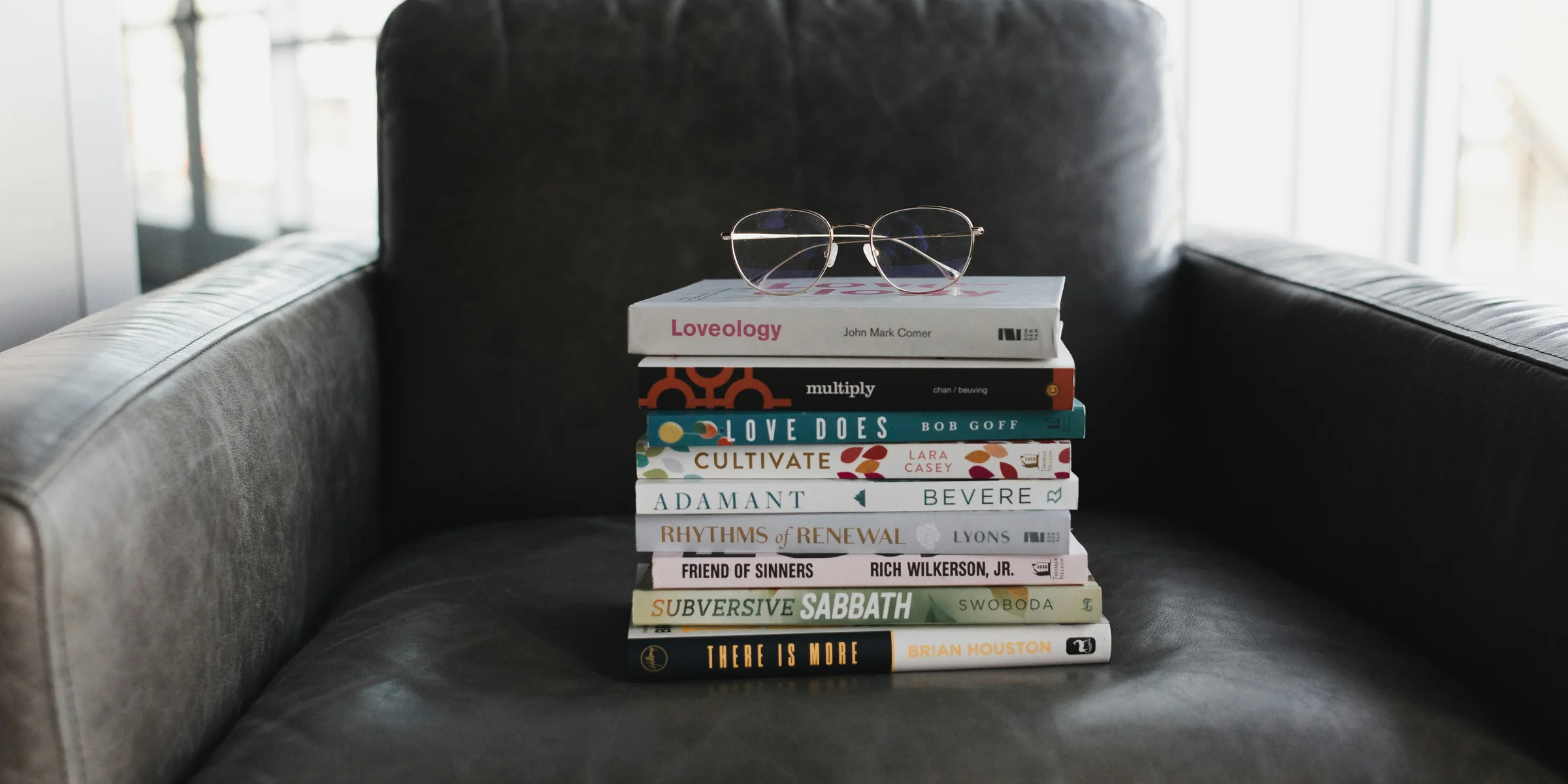 assorted books on black couch.