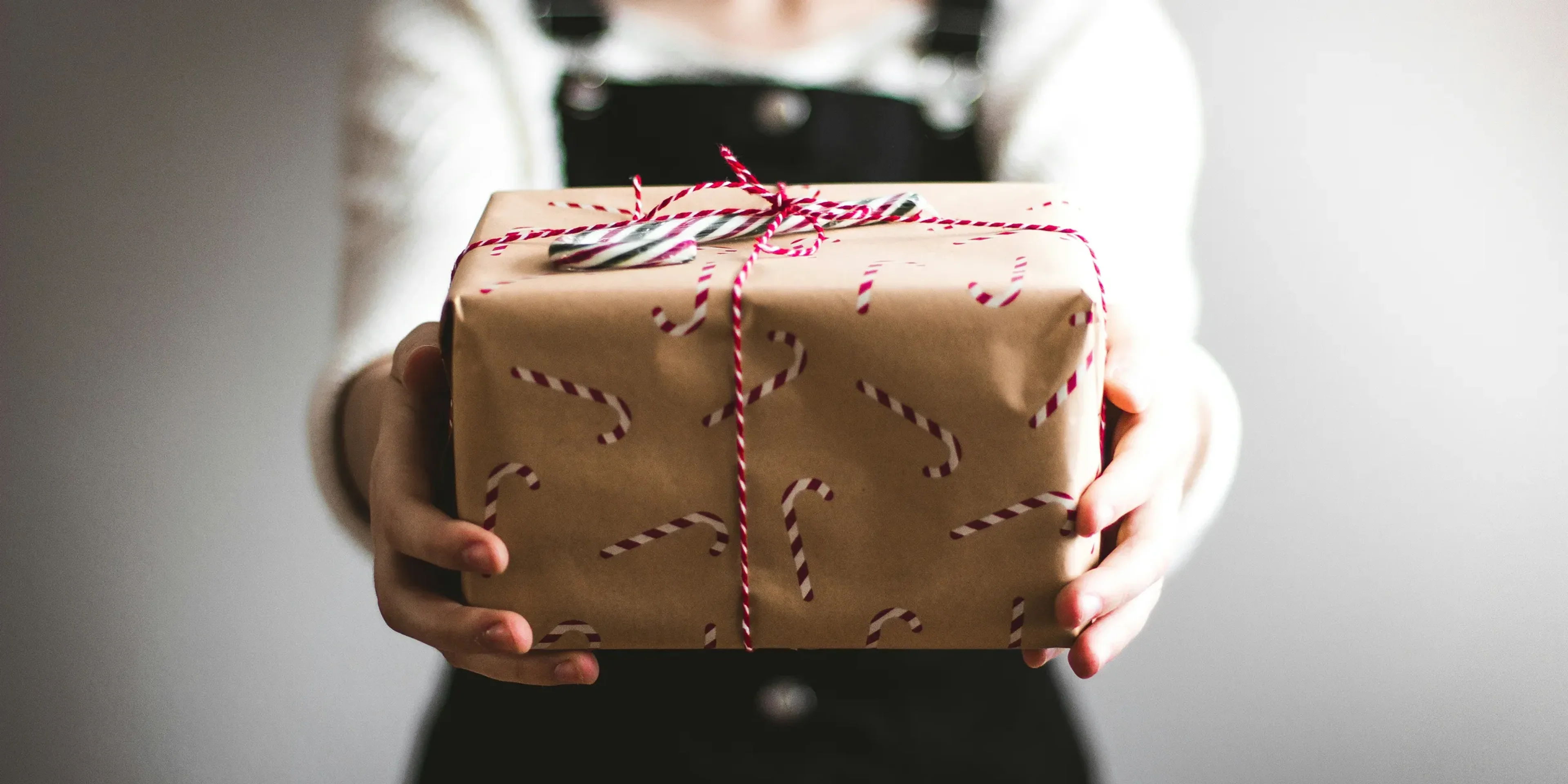 person showing brown gift box