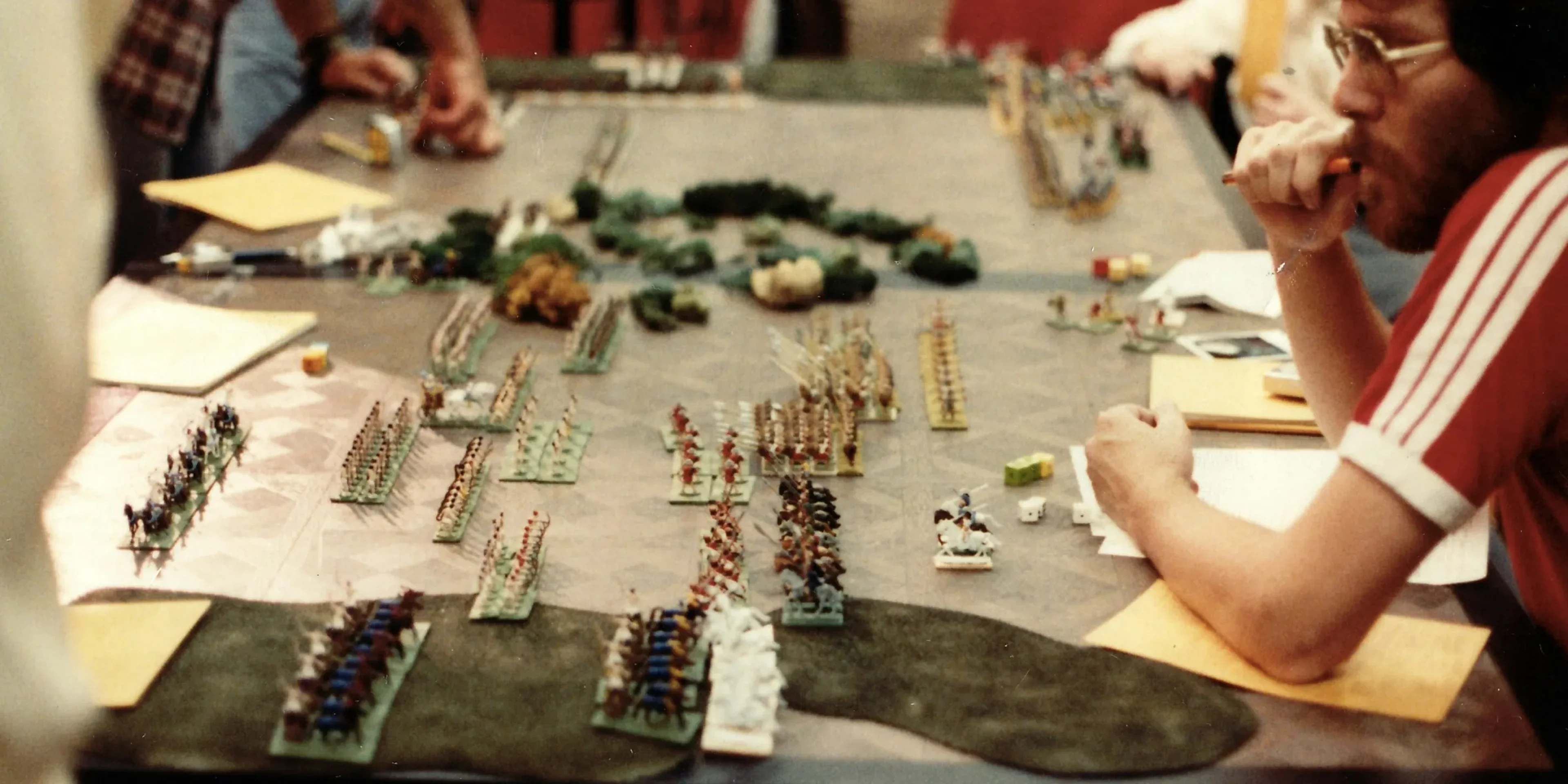 a group of people sitting around a table playing a game