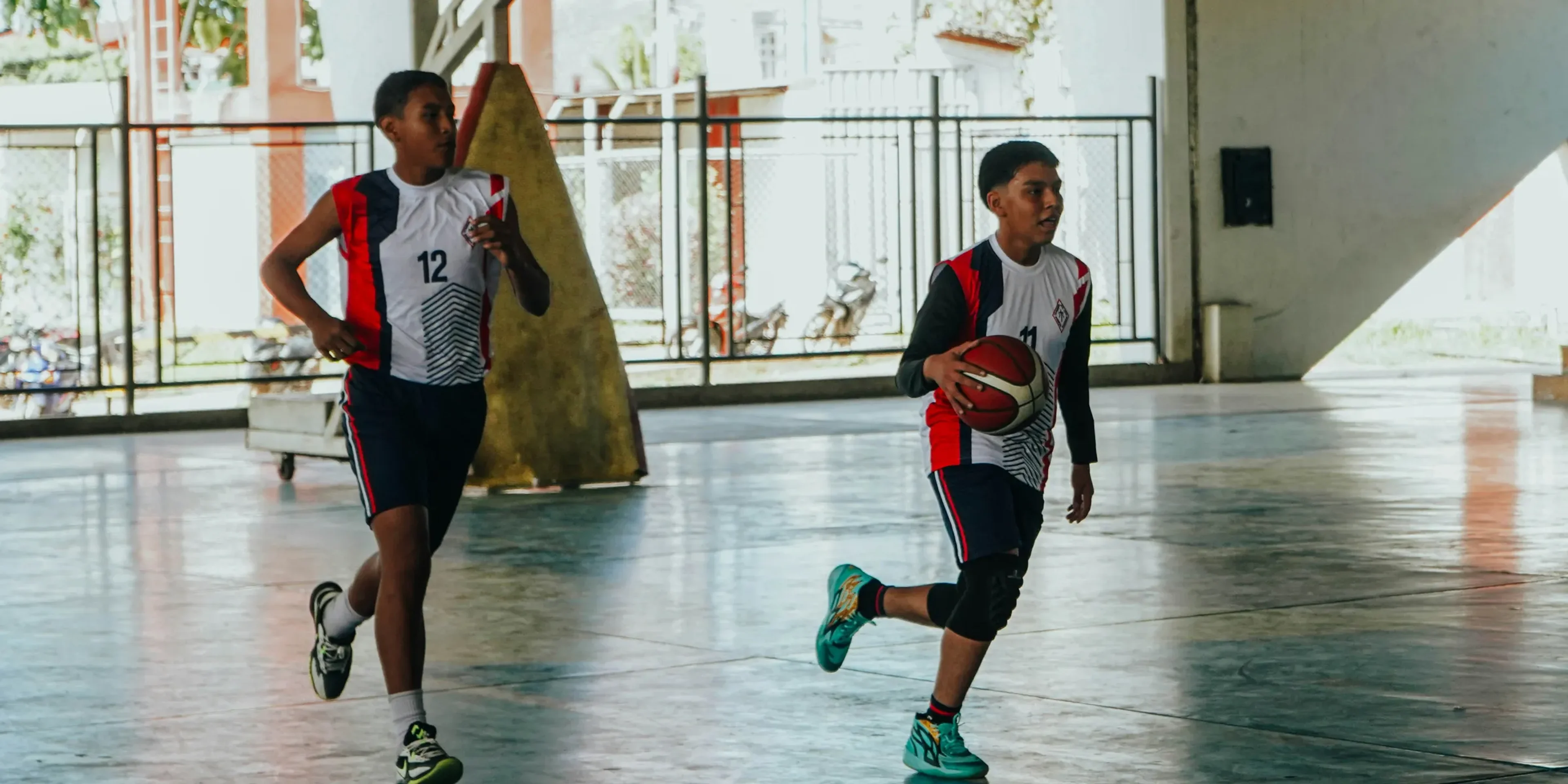 A group of young men playing a game of basketball