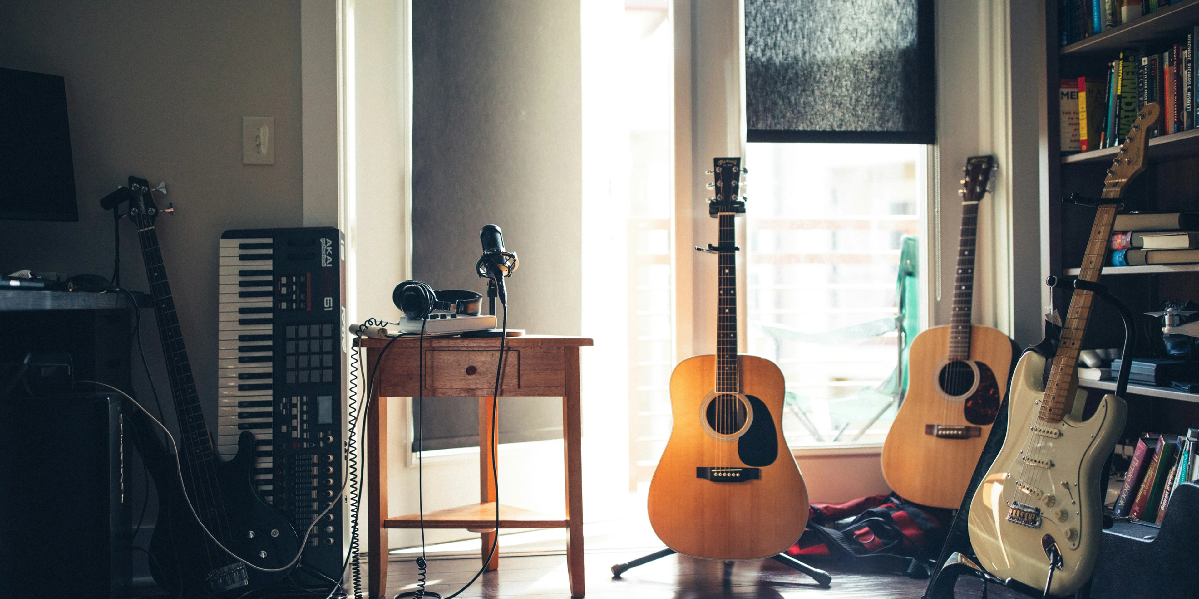 several guitars beside of side table.