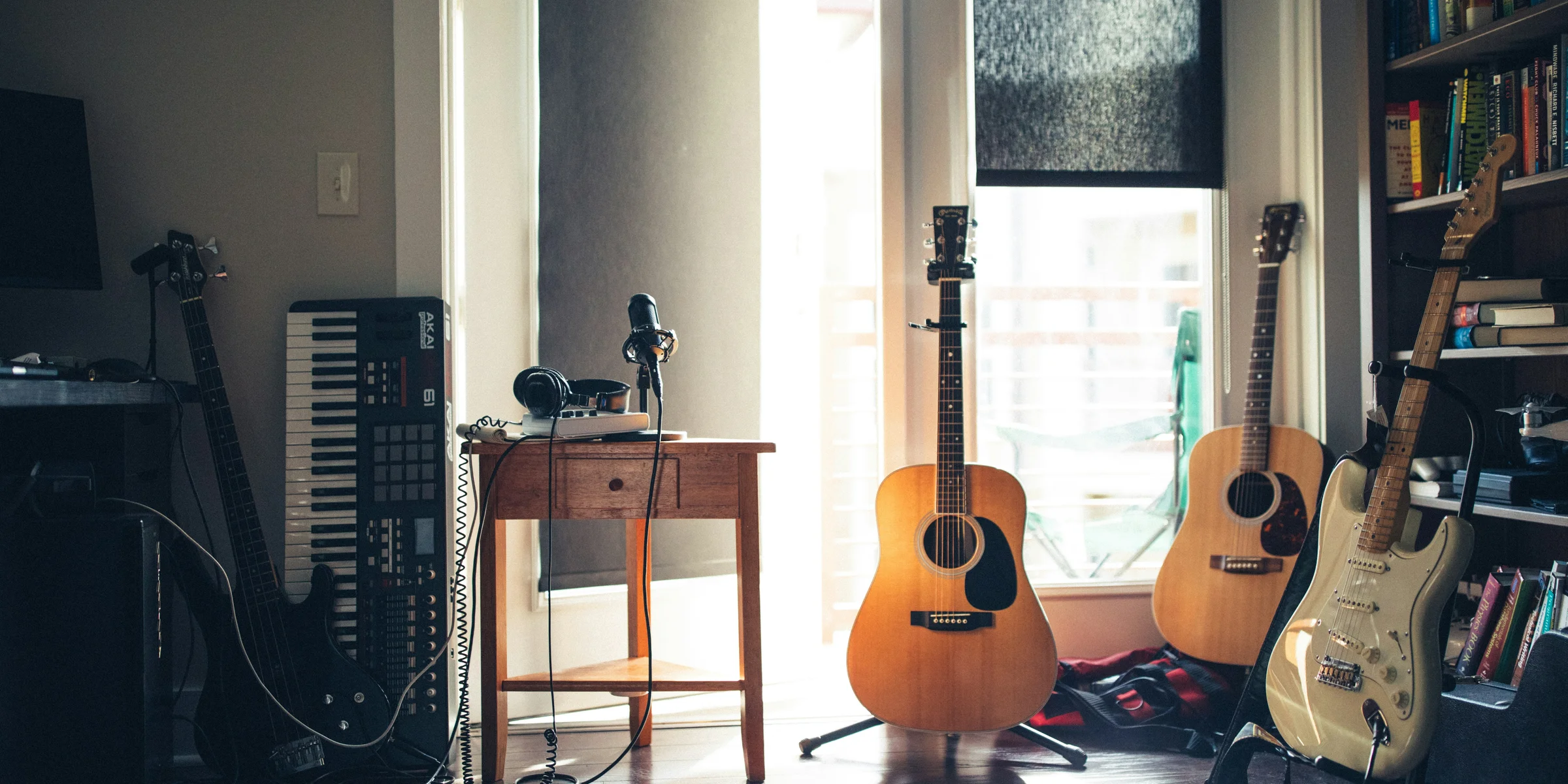 several guitars beside of side table.