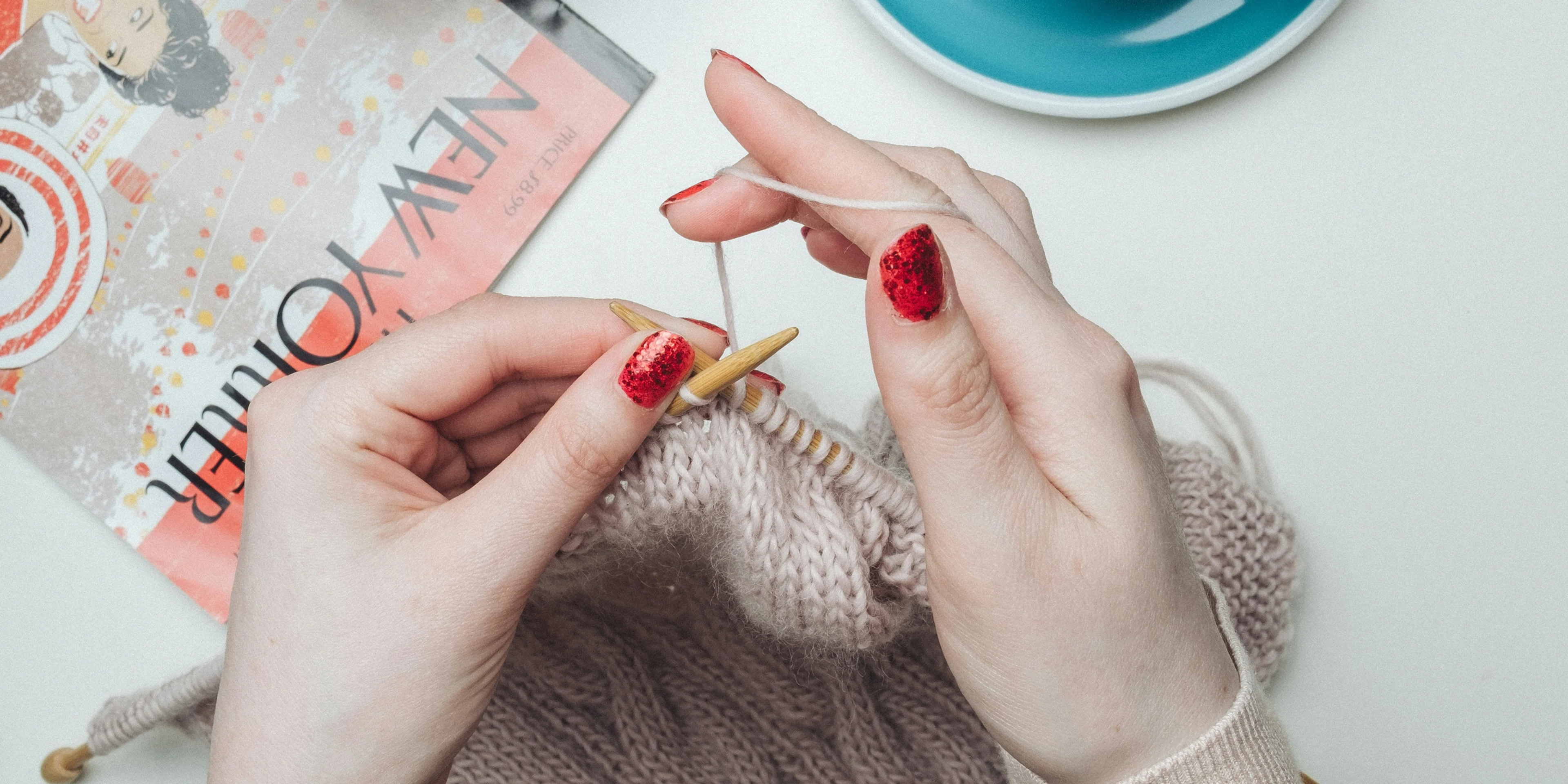person knitting beige garment