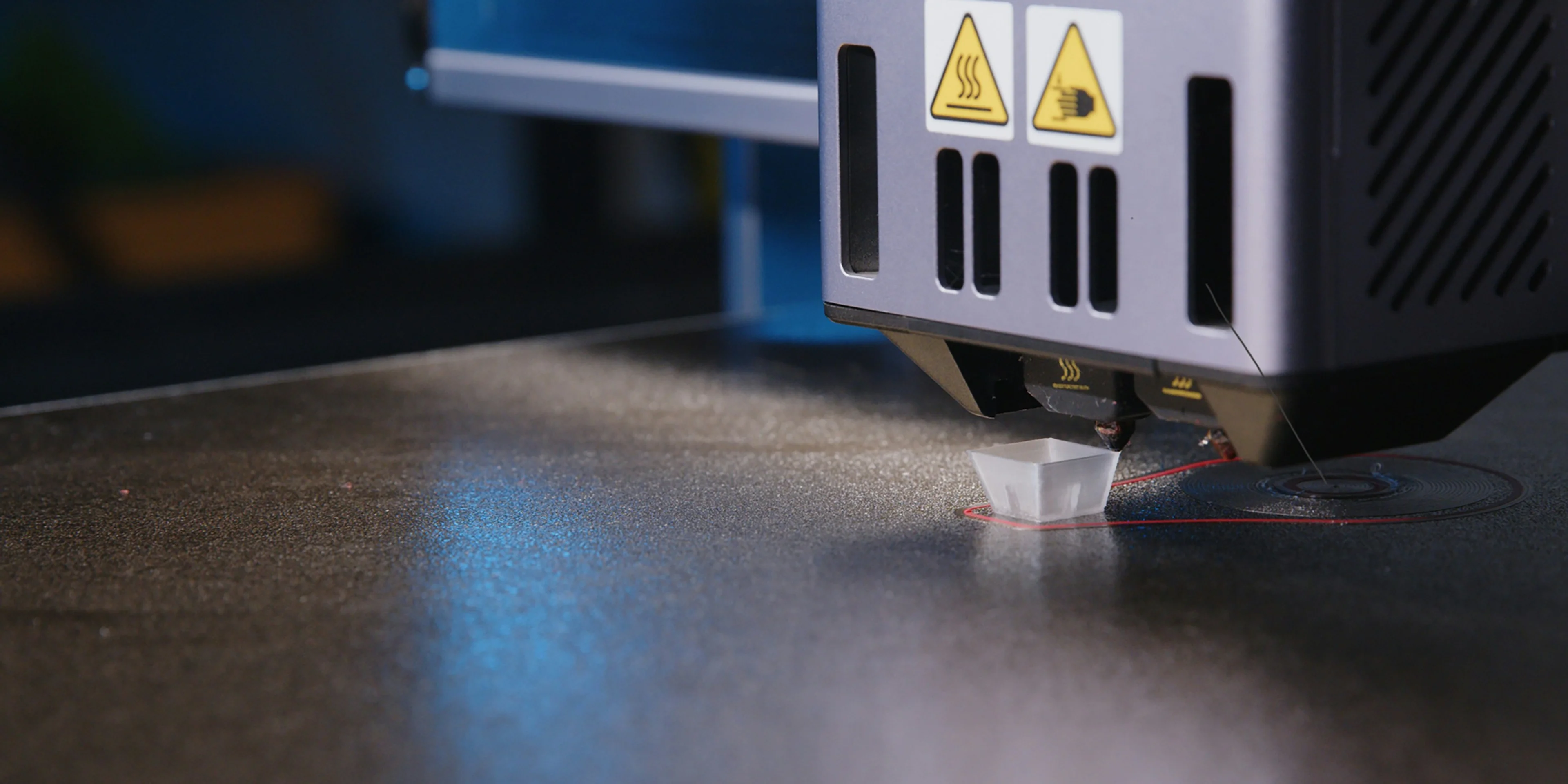 A close up of a machine that is cutting something.