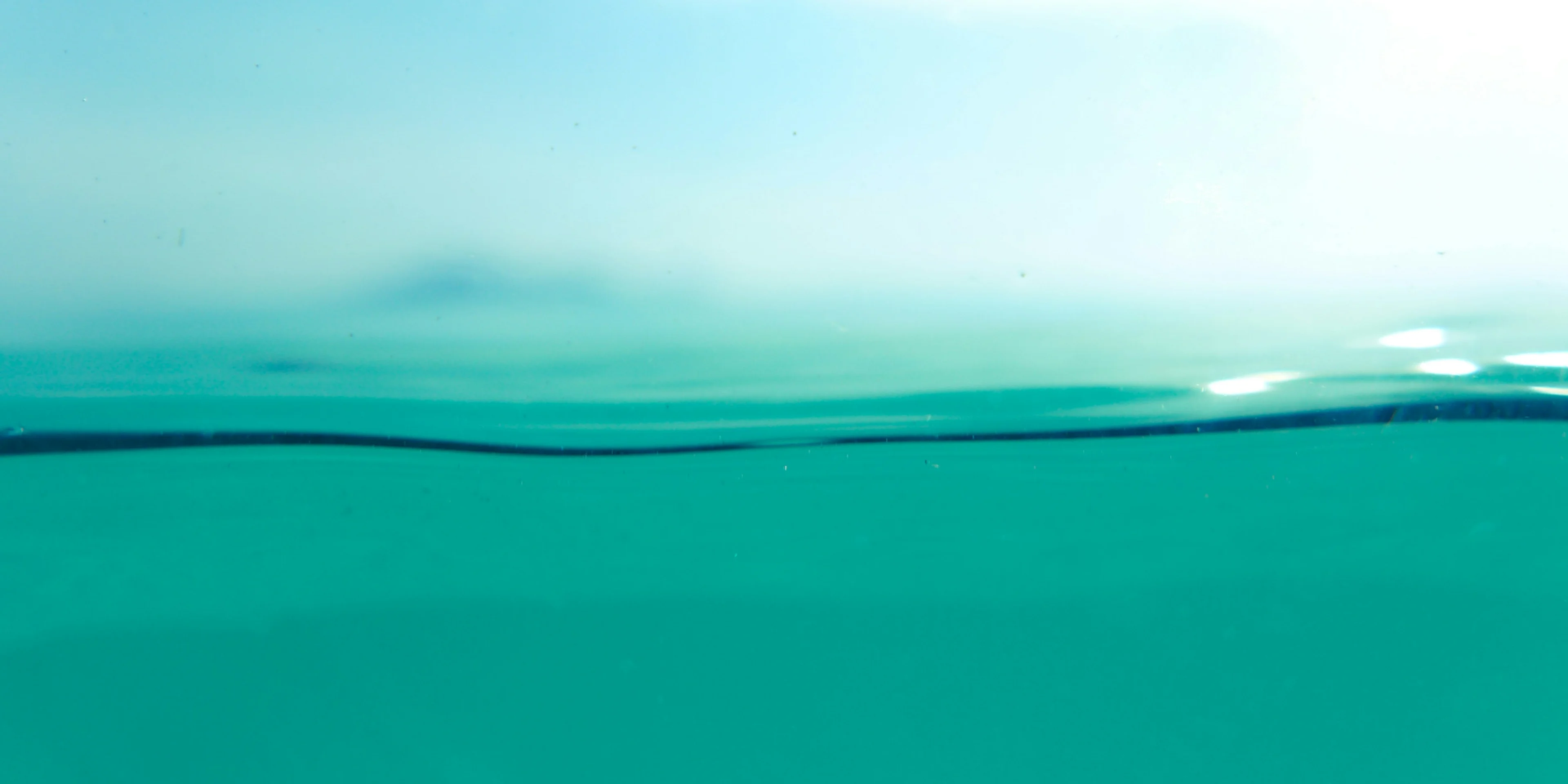 a view of the water from the bottom of a boat