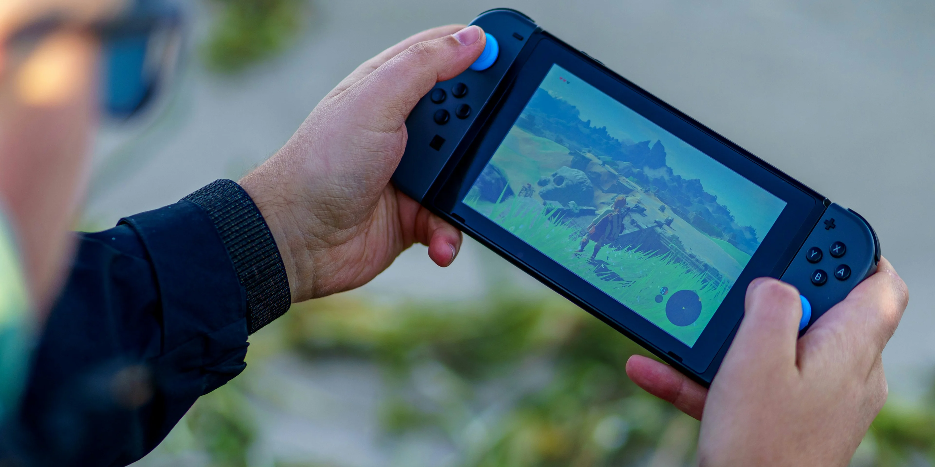 a person is playing a video game on a cell phone.