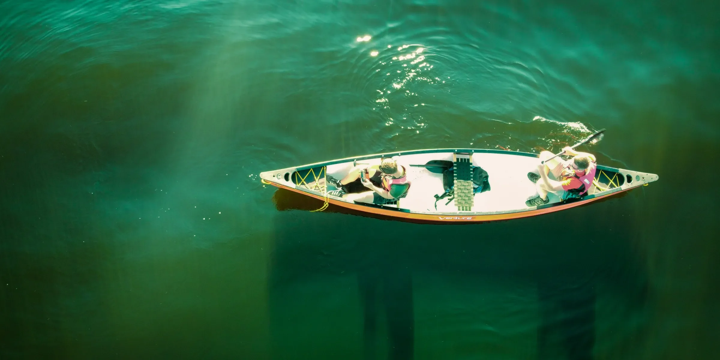 white and brown boat on body of water during daytime