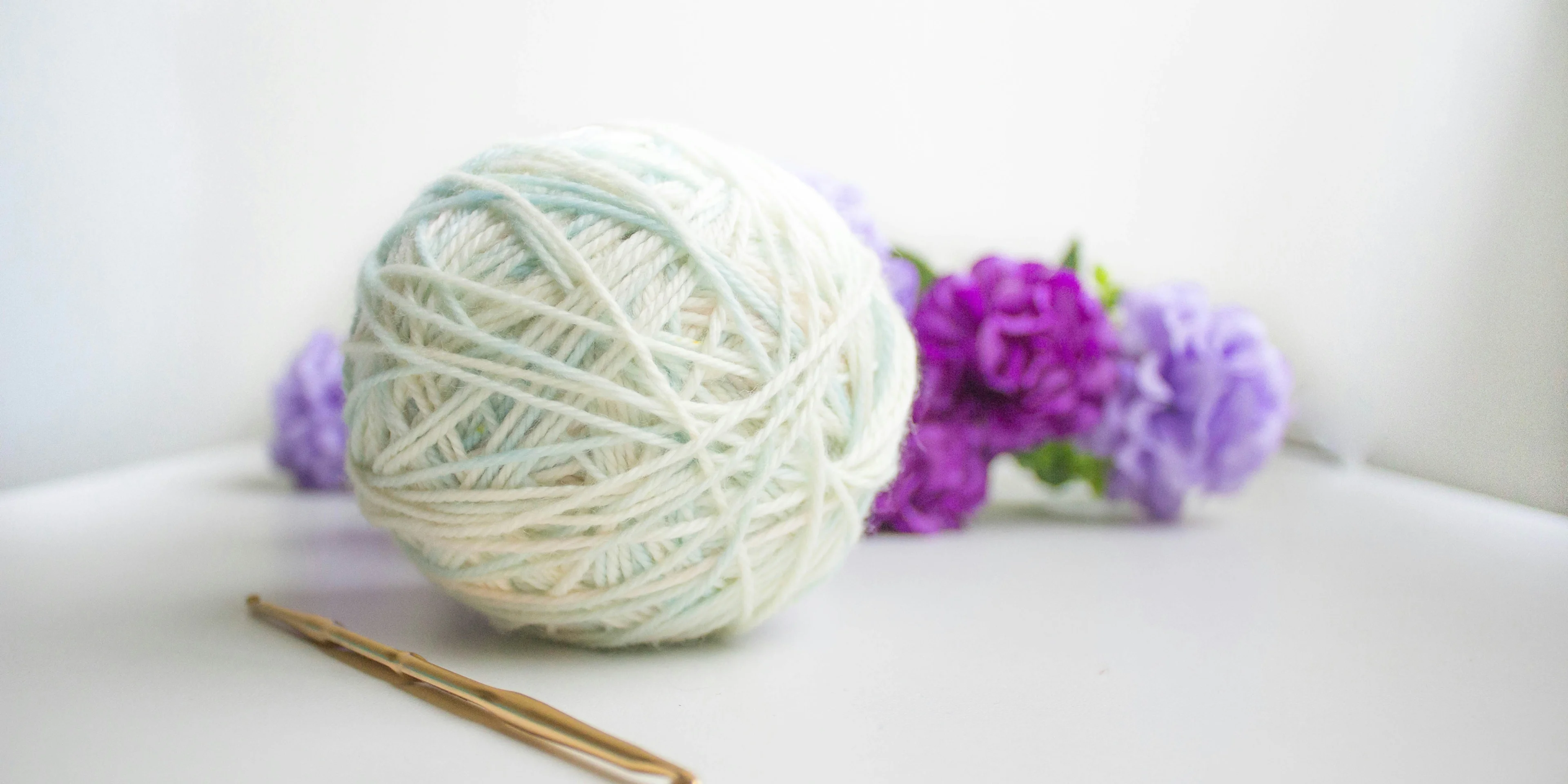 green and purple yarn ball