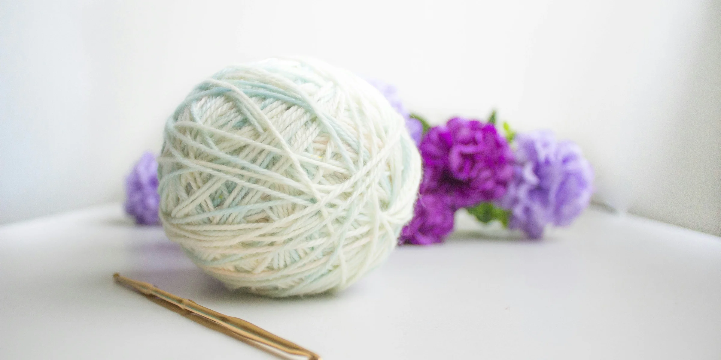 green and purple yarn ball