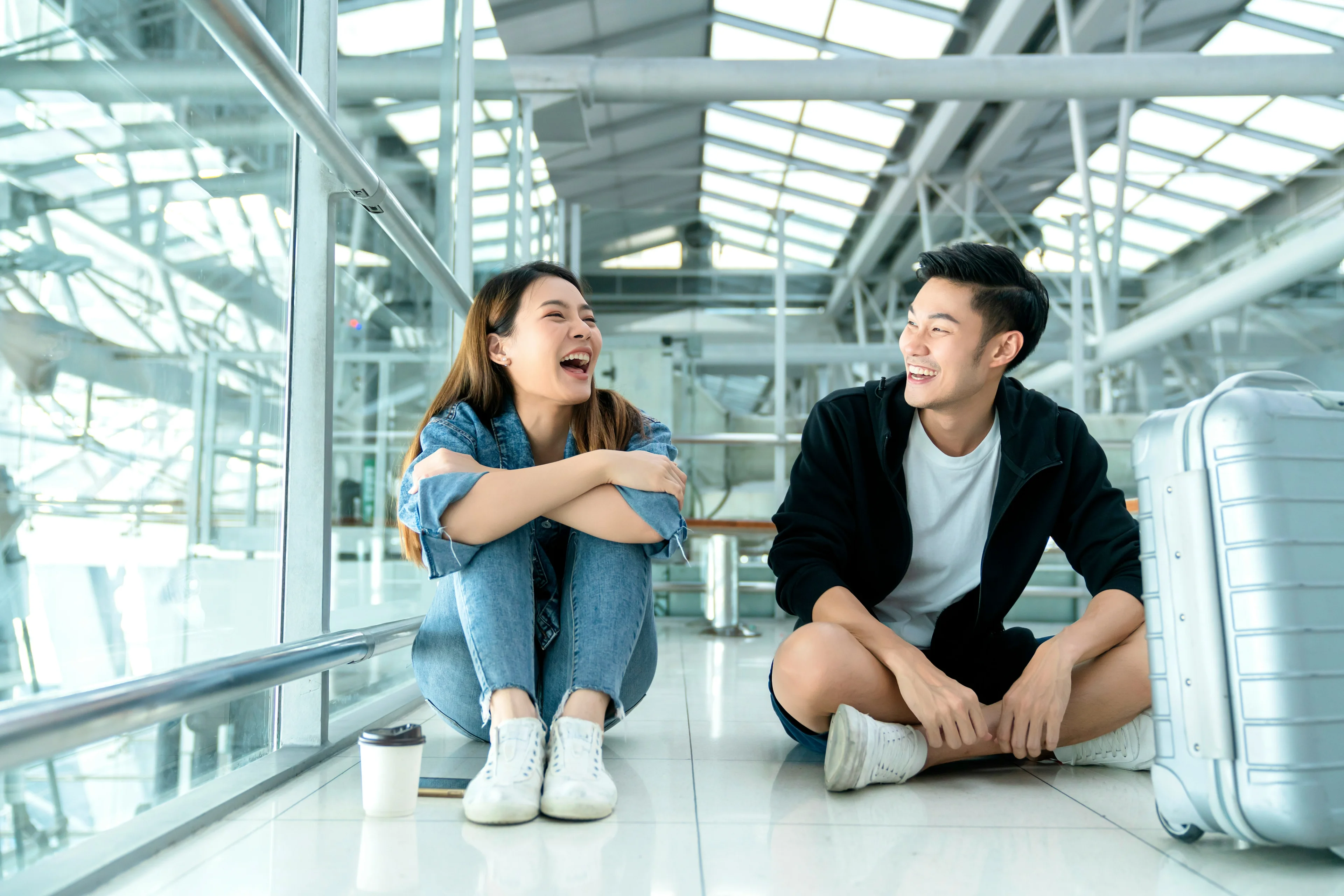 two people happily sitting at the airport