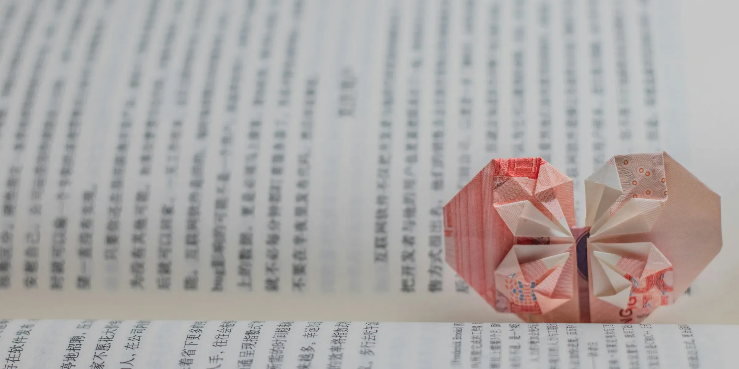 red and white paper boat on white printer paper