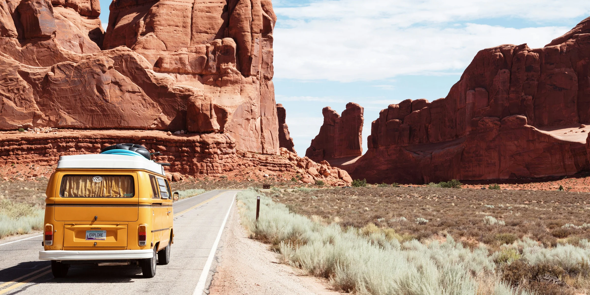 yellow Volkswagen van on road.