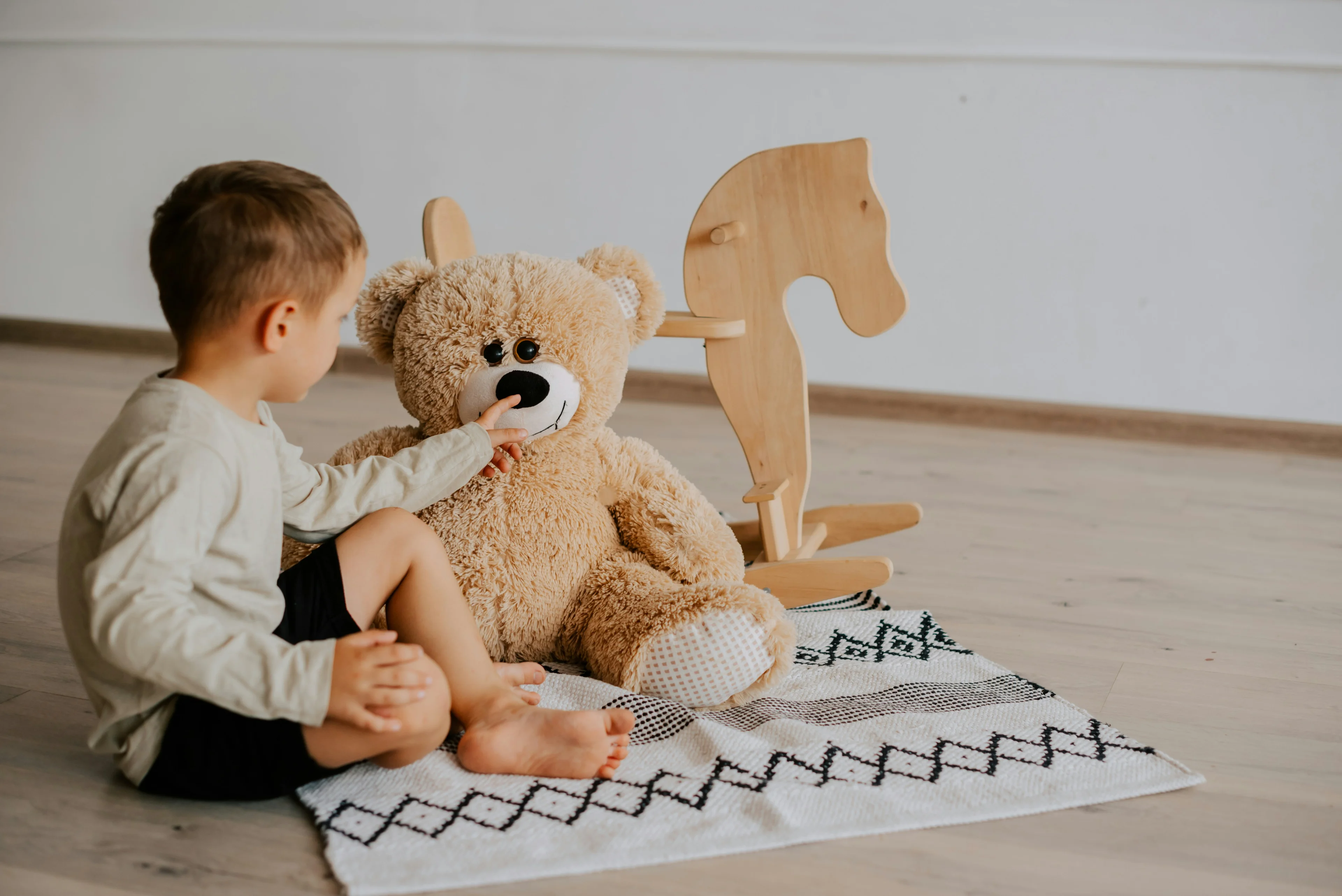 child with stuffed bear