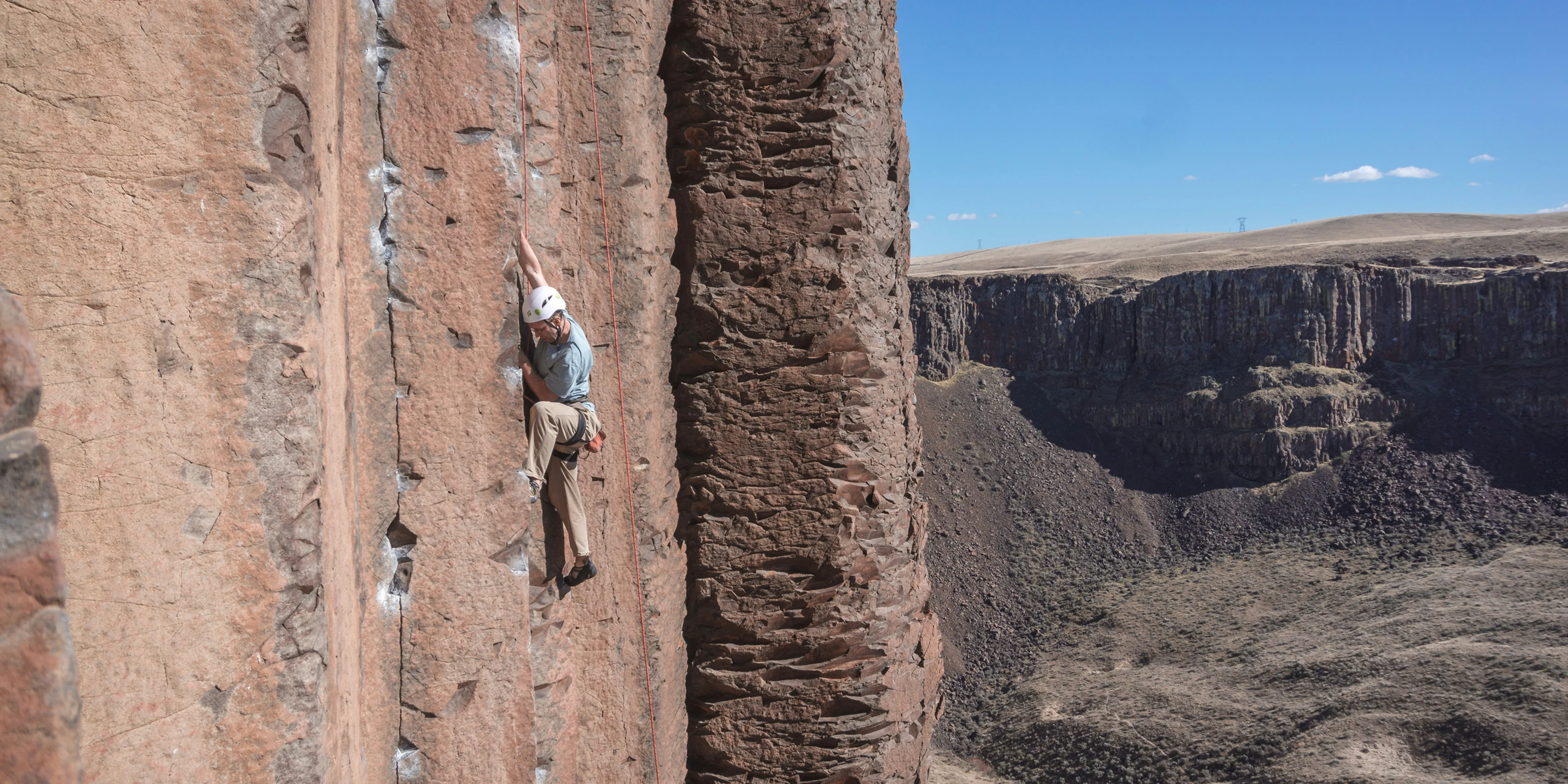 man mountain climbing during daytime