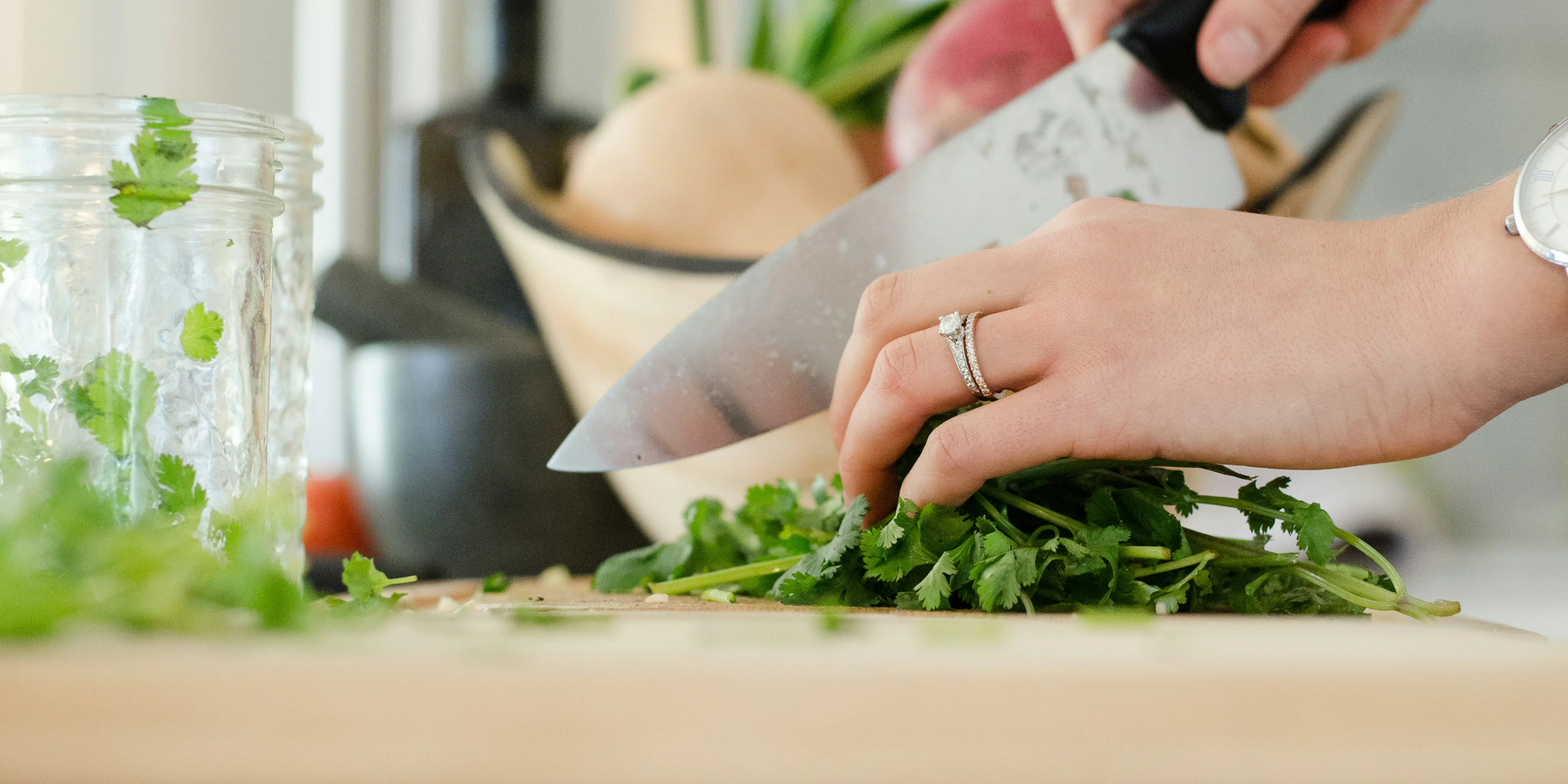 person cutting vegetables with knife.