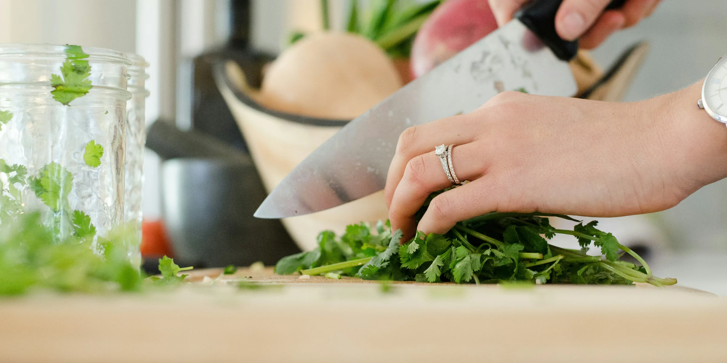 person cutting vegetables with knife.