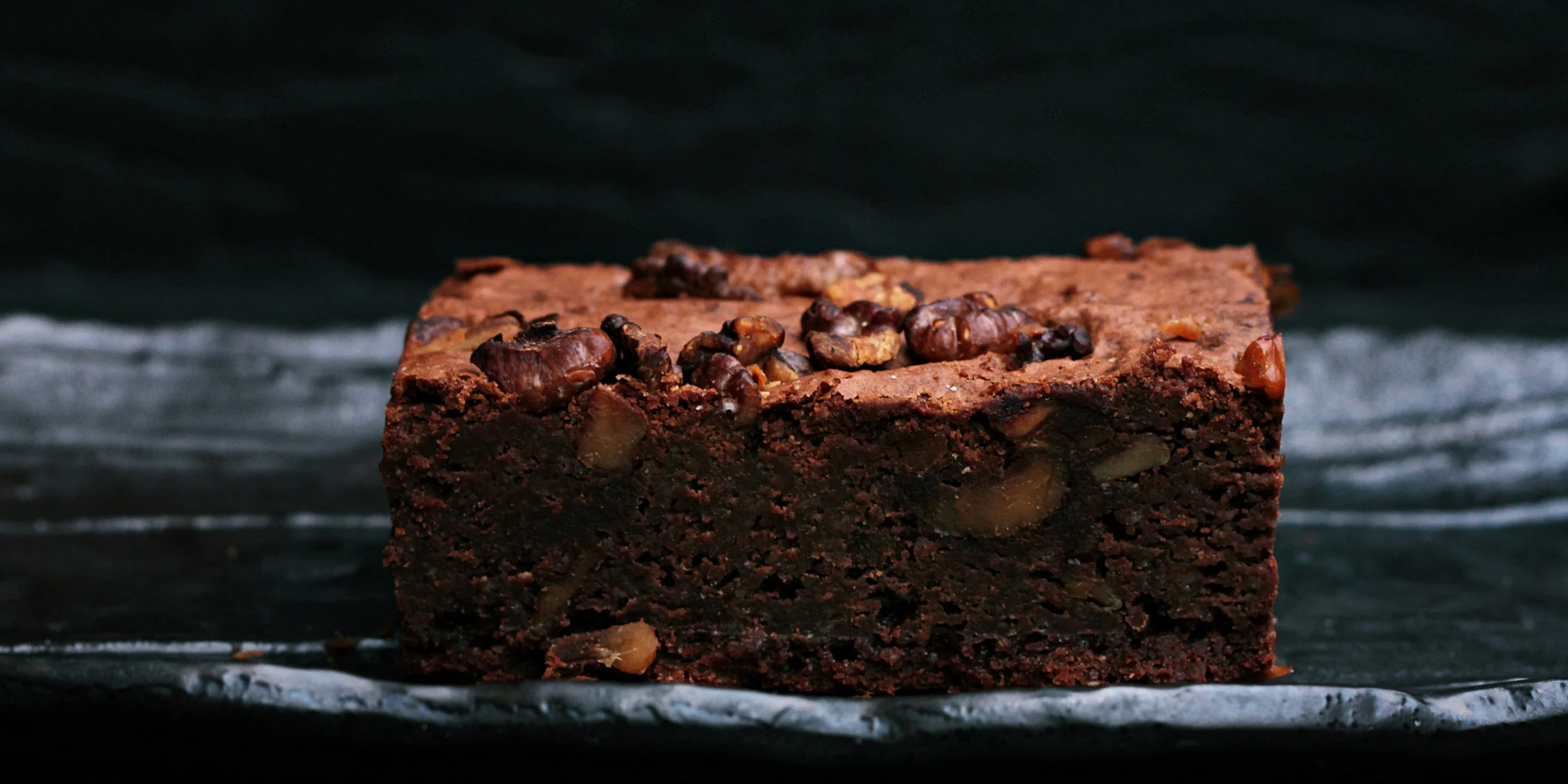 sliced baked brownies on foiled tray.