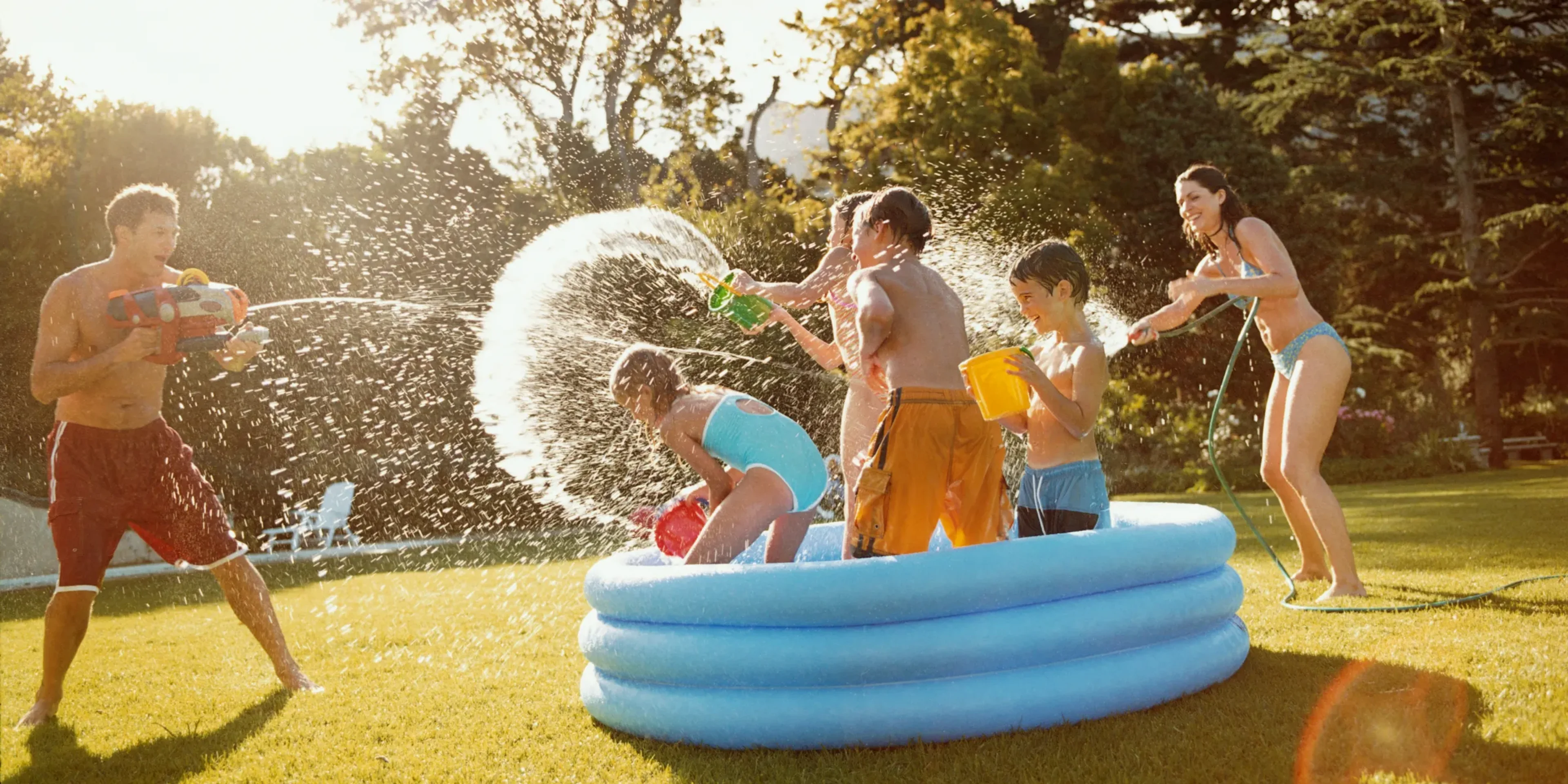 family having fun in a kiddie pool outdoors