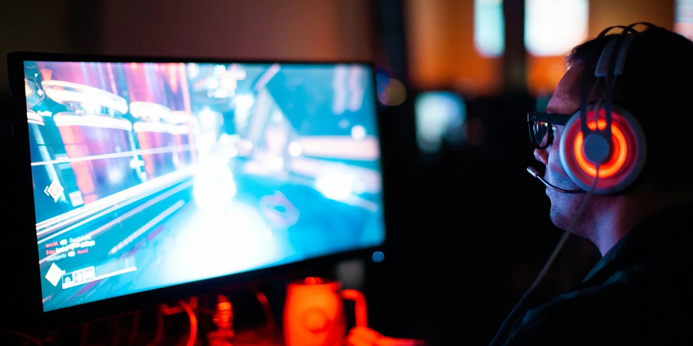 person using computer playing FPS game.