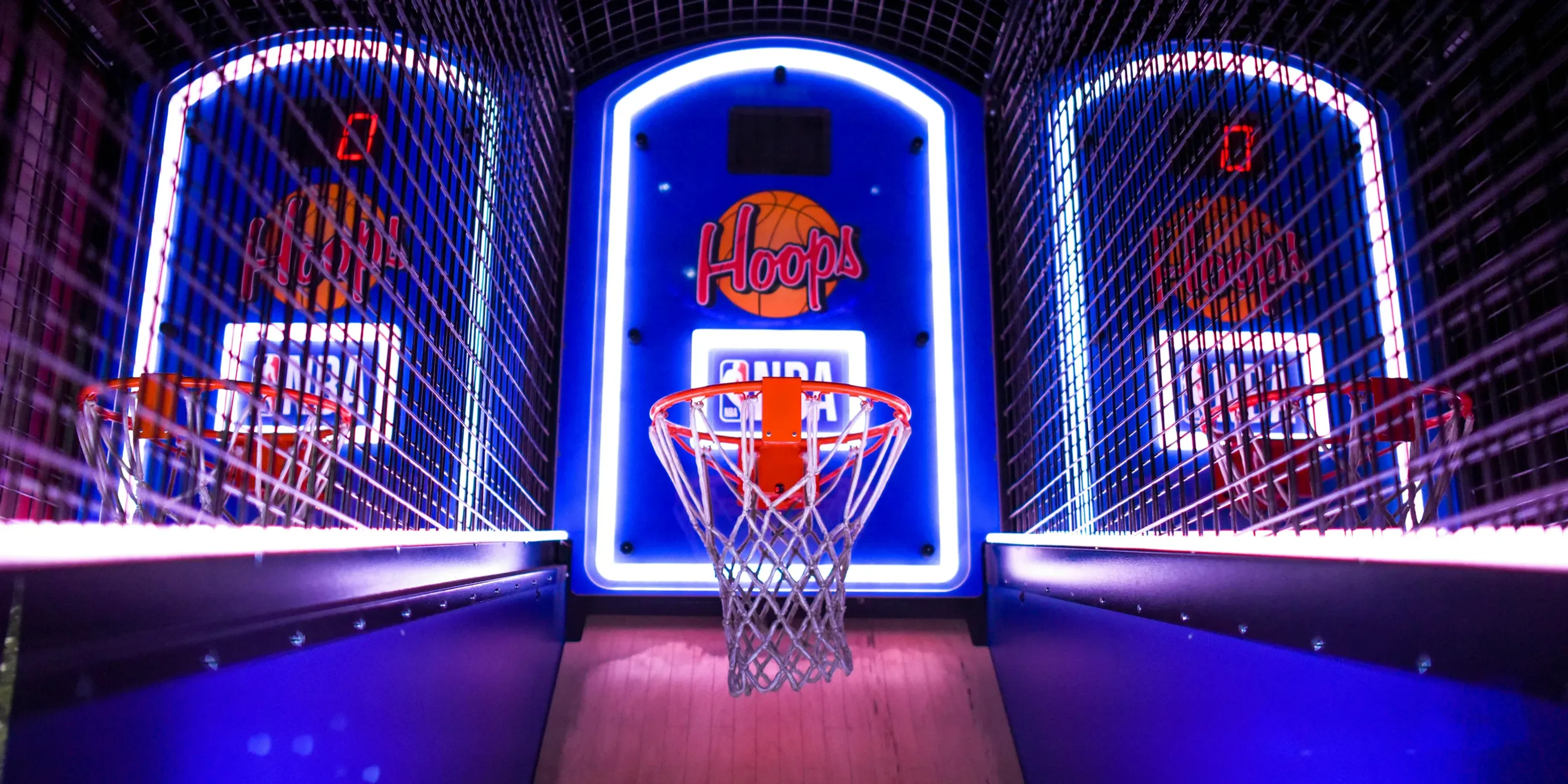 three arcade basketball hoops with lights