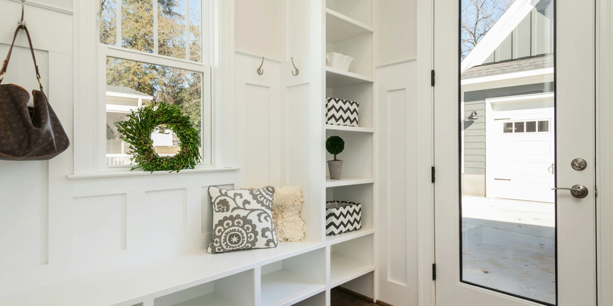 gray and white floral throw pillow beside rack inside room.