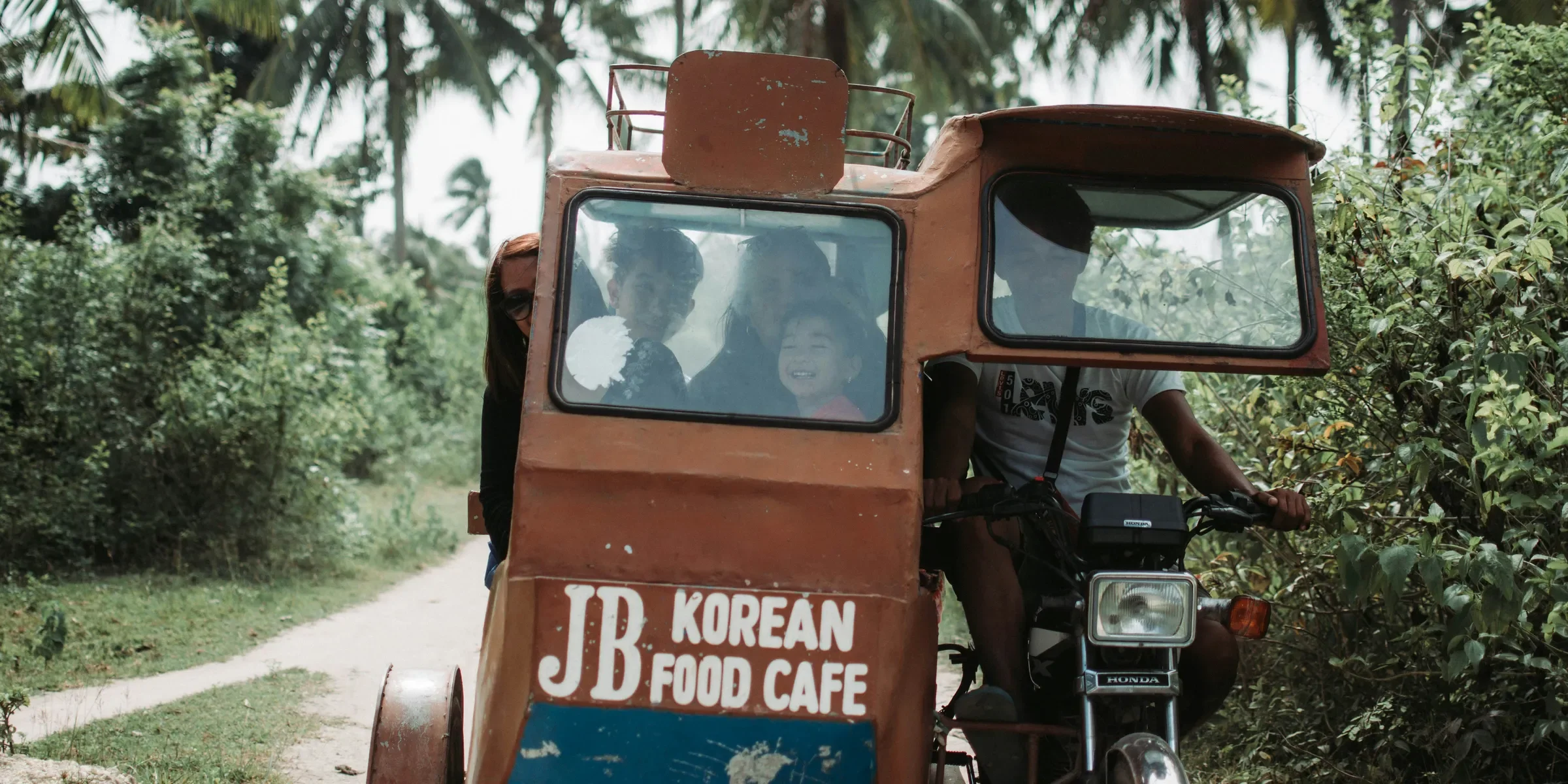 people riding tricycle during daytime