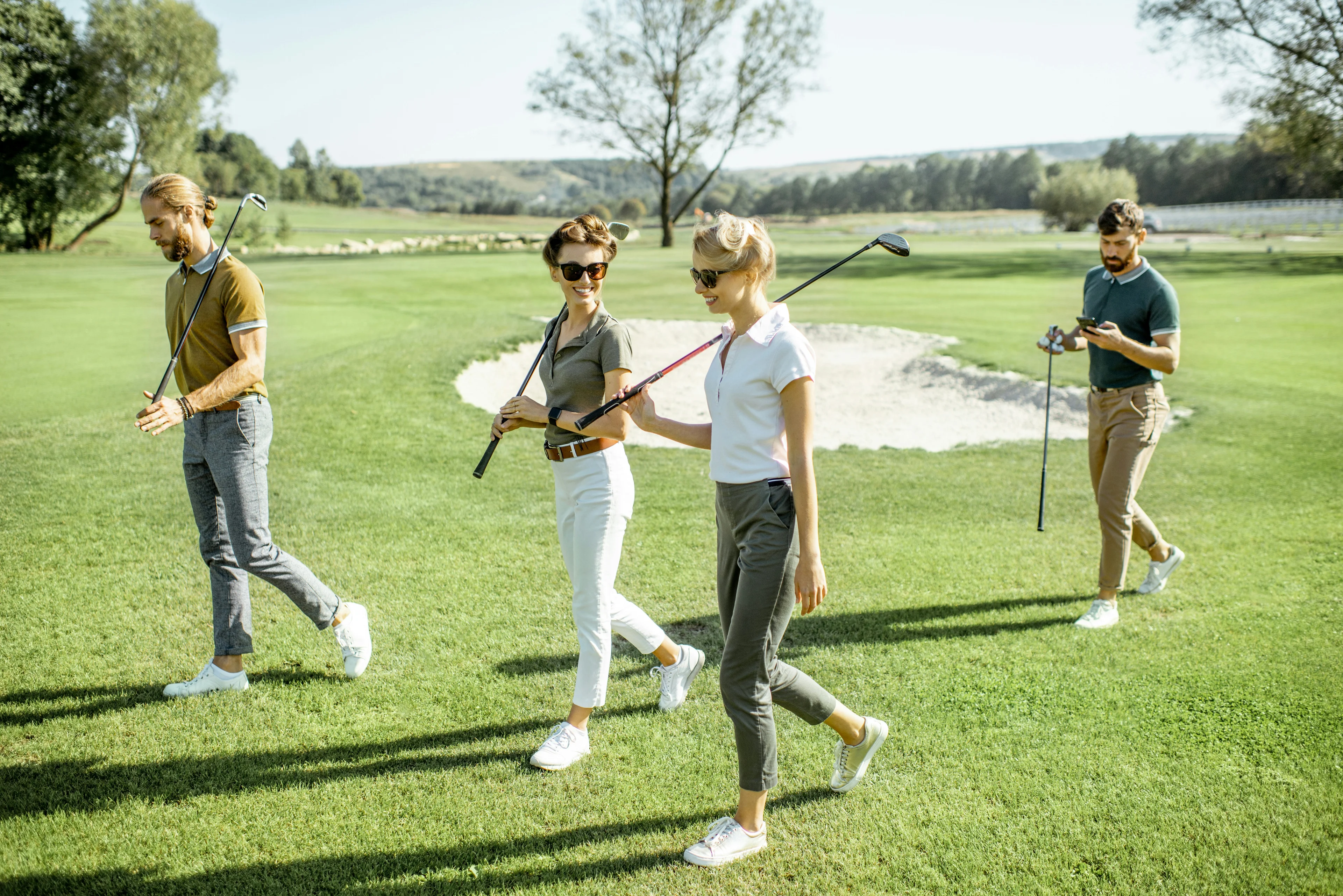 Happy friends golfing