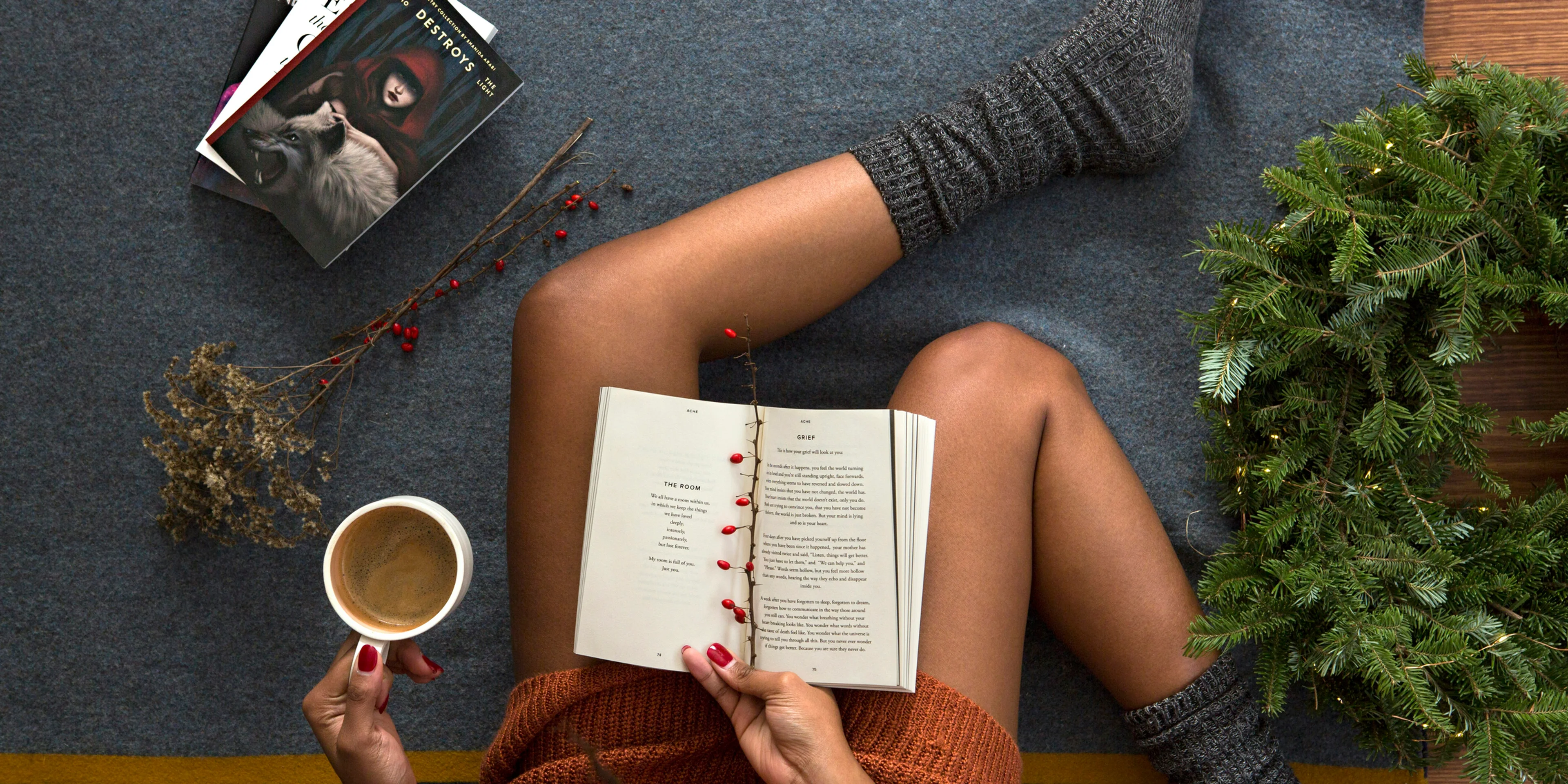 opened book on person's lap with gray socks.