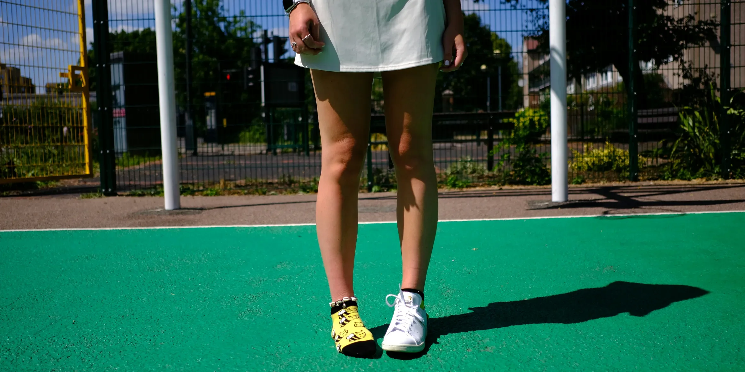 A woman standing on a tennis court holding a racquet