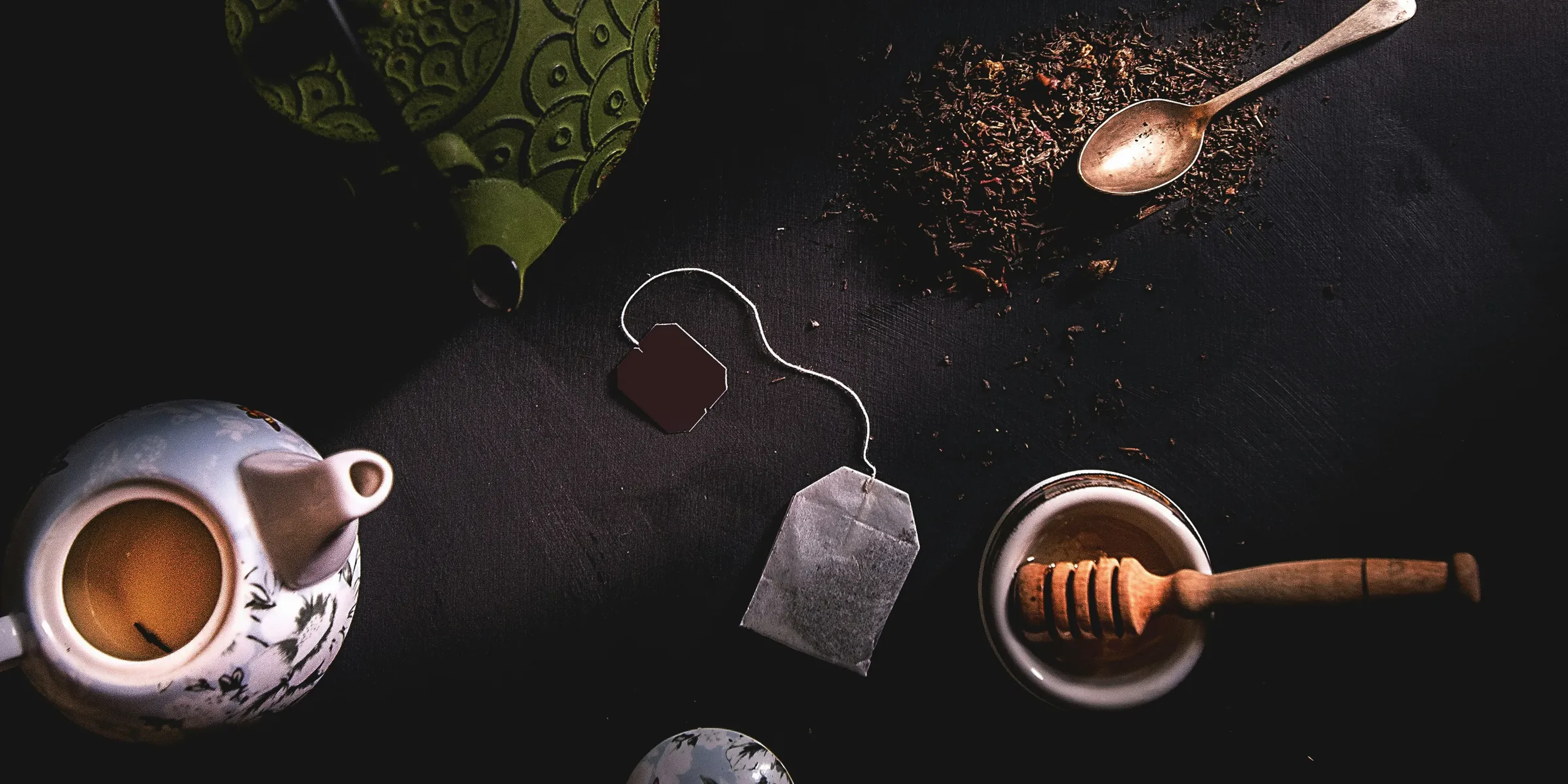 two teapots beside mortar and pestle