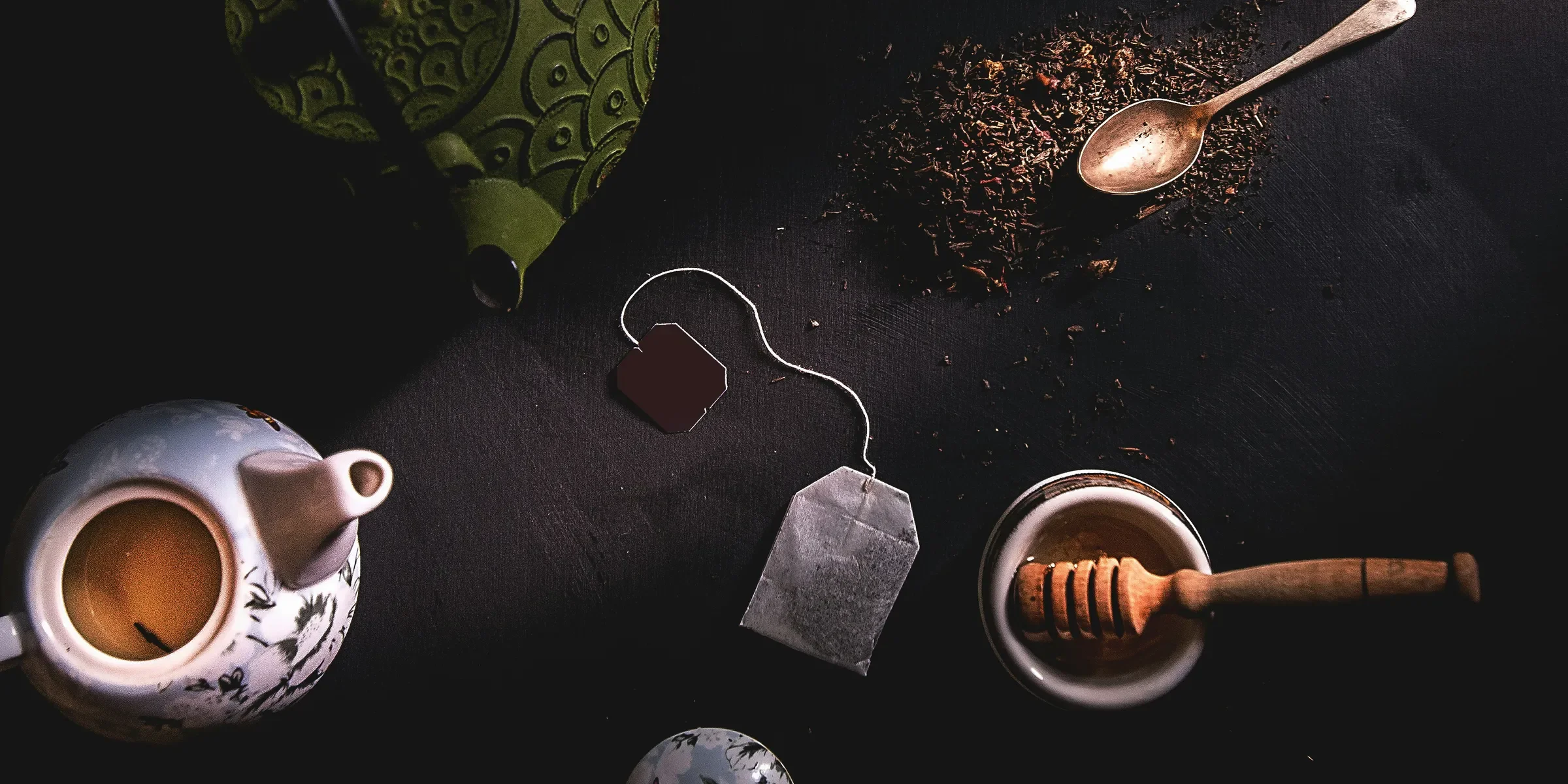 two teapots beside mortar and pestle