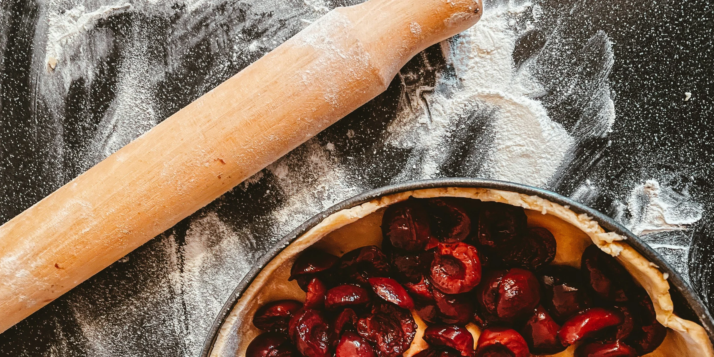 brown wooden rolling pin on stainless steel bowl.